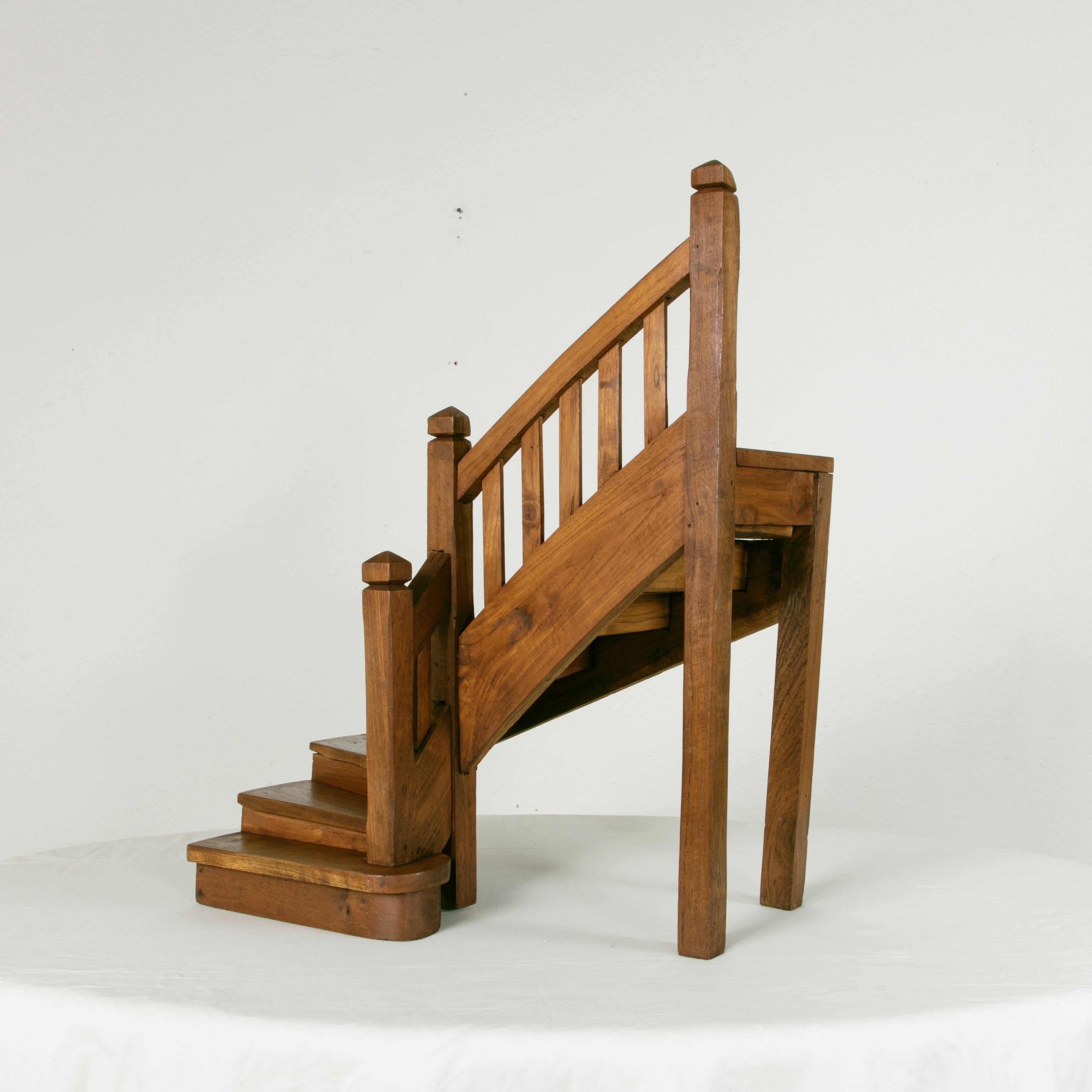 This solid walnut and cherrywood model staircase is a rare find. An unusually large-scale model, this piece displays beautifully on its own as a centerpiece for an entry table or on a large desk. A sought after example of French craftsmanship, with