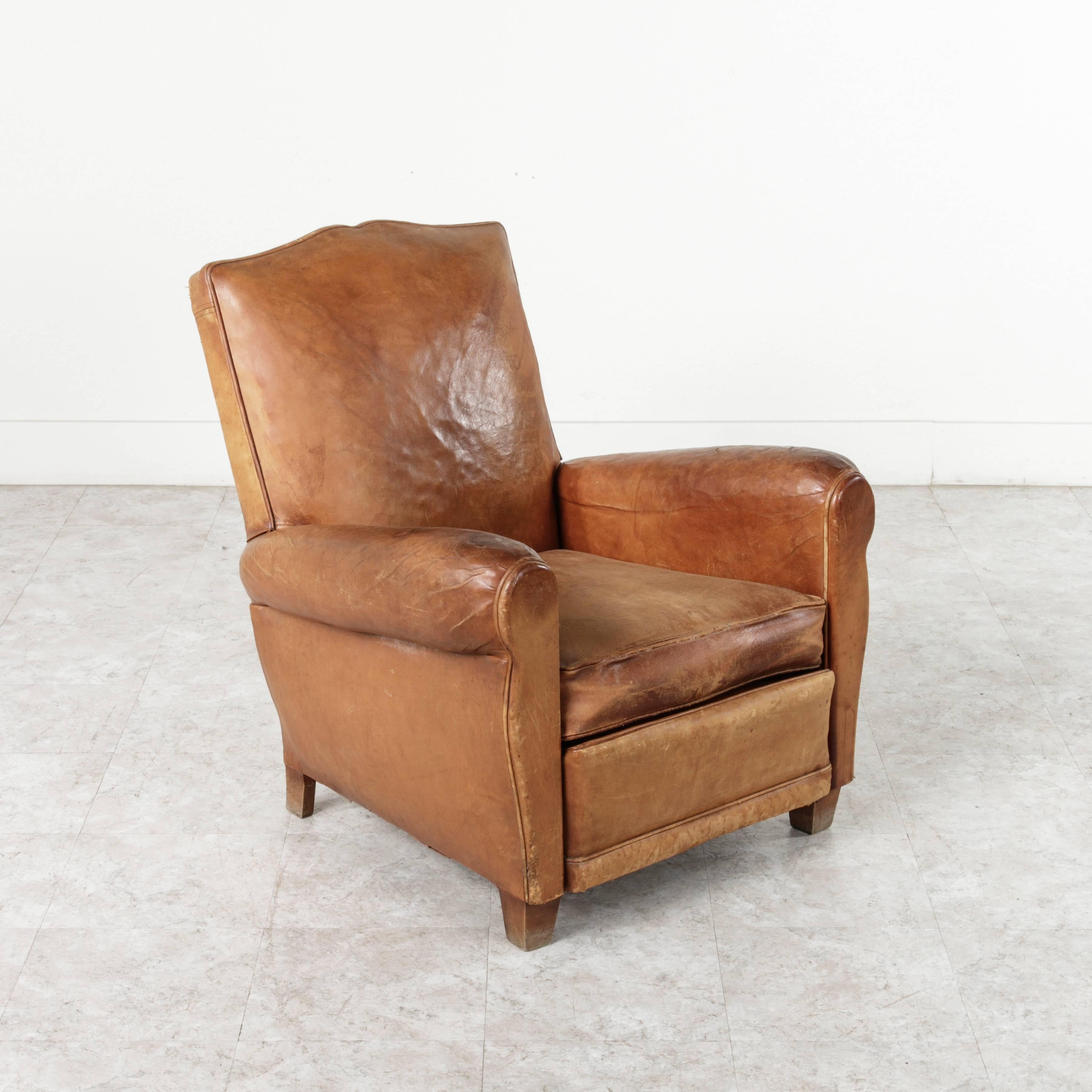 This pair of French Art Deco period moustache back club chairs have a unique historical feel. With a design created during the Art Moderne movement in 1920s-1940s, France, these chairs define an era of Parisian style. The age of the original leather