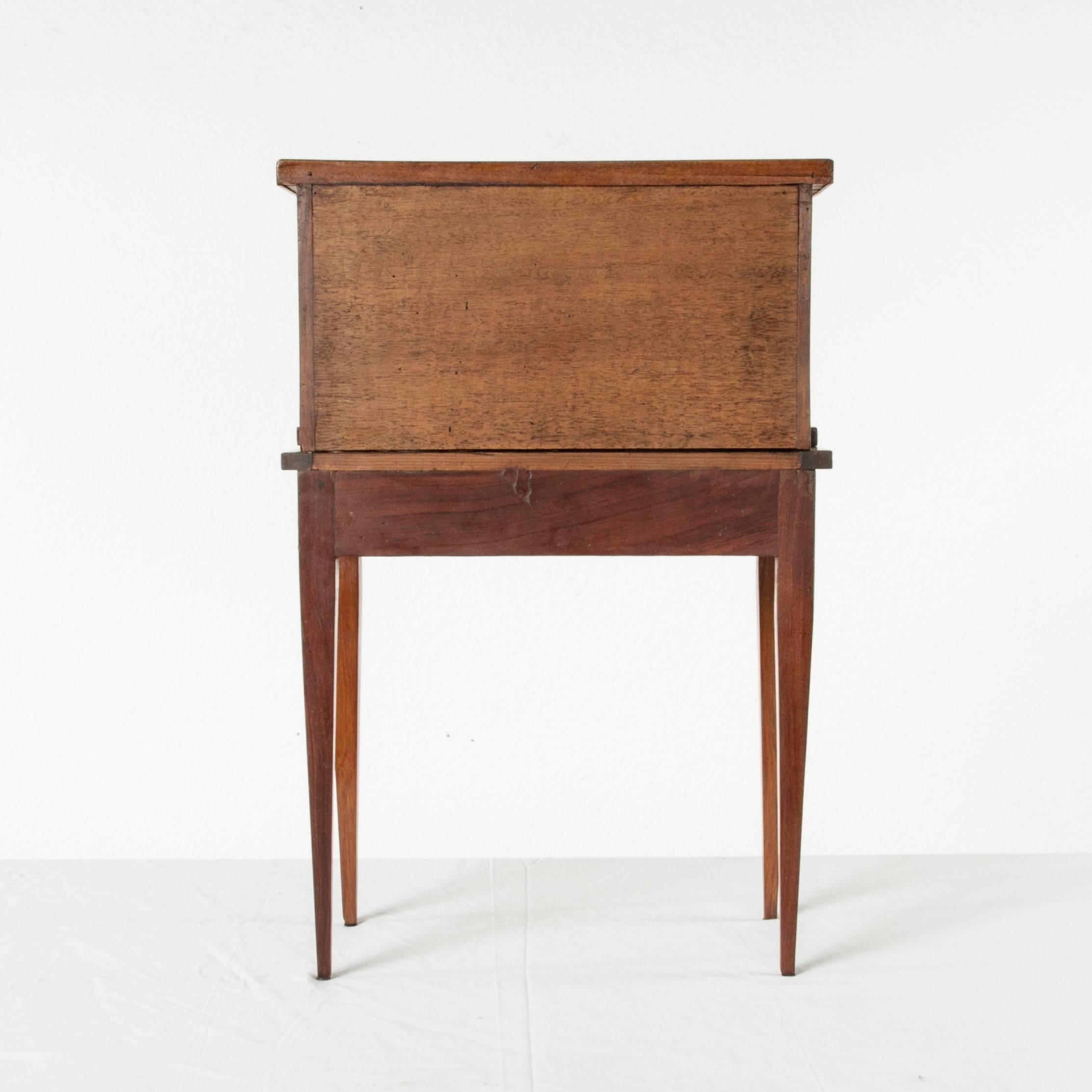 This rare 19th century miniature Louis XVI style model writing desk or bonheur du jour features an upper cabinet and fold out leather top writing surface. Called a bonheur du jour in French, this meuble de maitrise was created as a masterwork of a