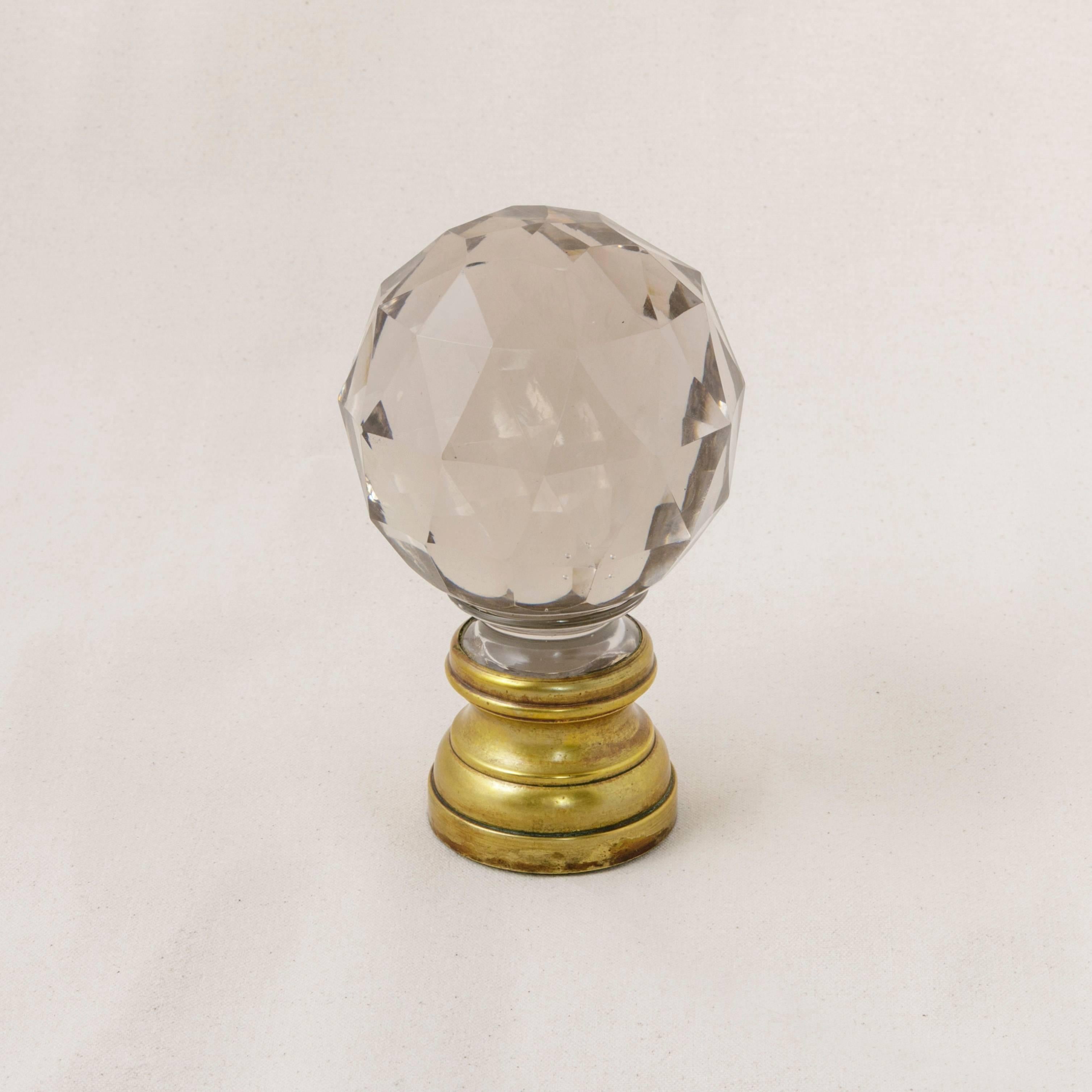 This gorgeous heavy crystal ball was made by Baccarat in France over 100 years ago. This beautifully faceted piece of crystal is mounted on a simple bronze base which is threaded to screw onto a staircase banister for secure attachment. A fantastic