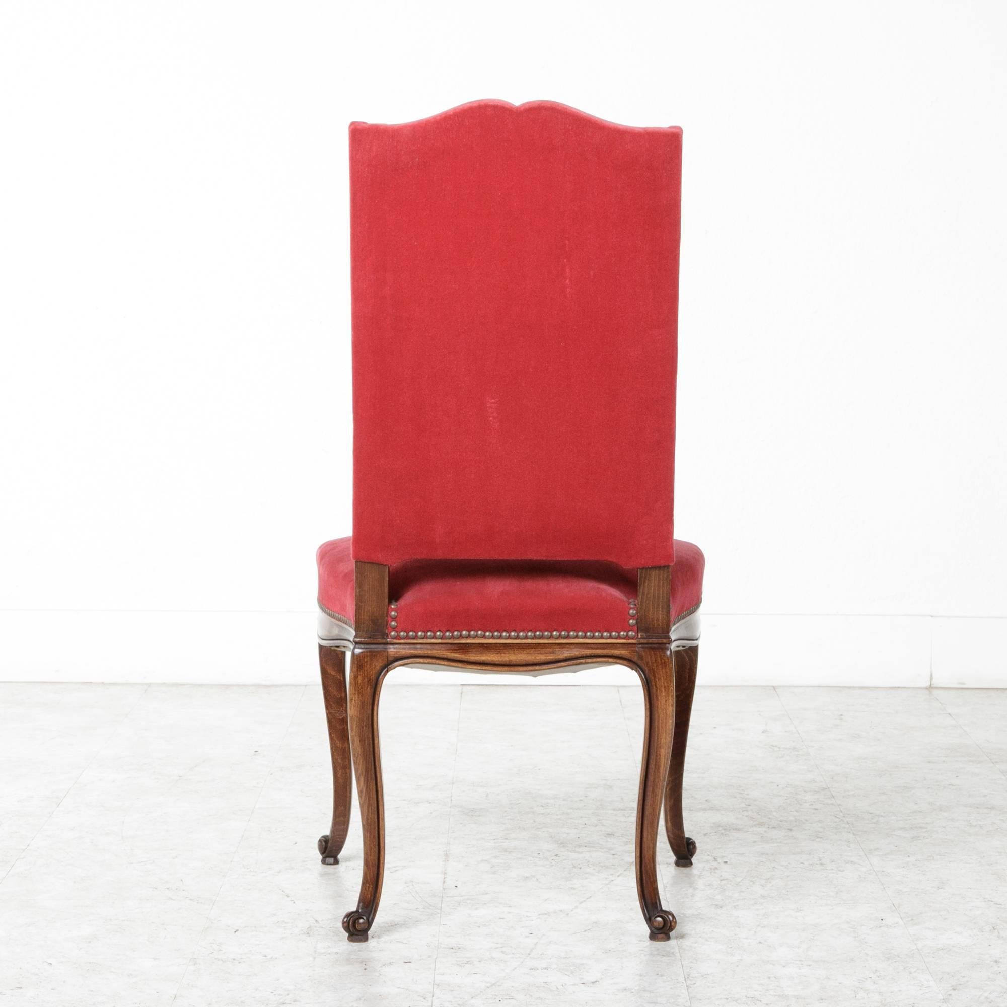 This charming set of six beechwood Louis XV style chairs were created in France, circa 1950. With comfortable wide seats, carved aprons and sinuous cabriole legs, this set of chairs has a lovely inviting feel. The vibrant red mohair upholstery is in