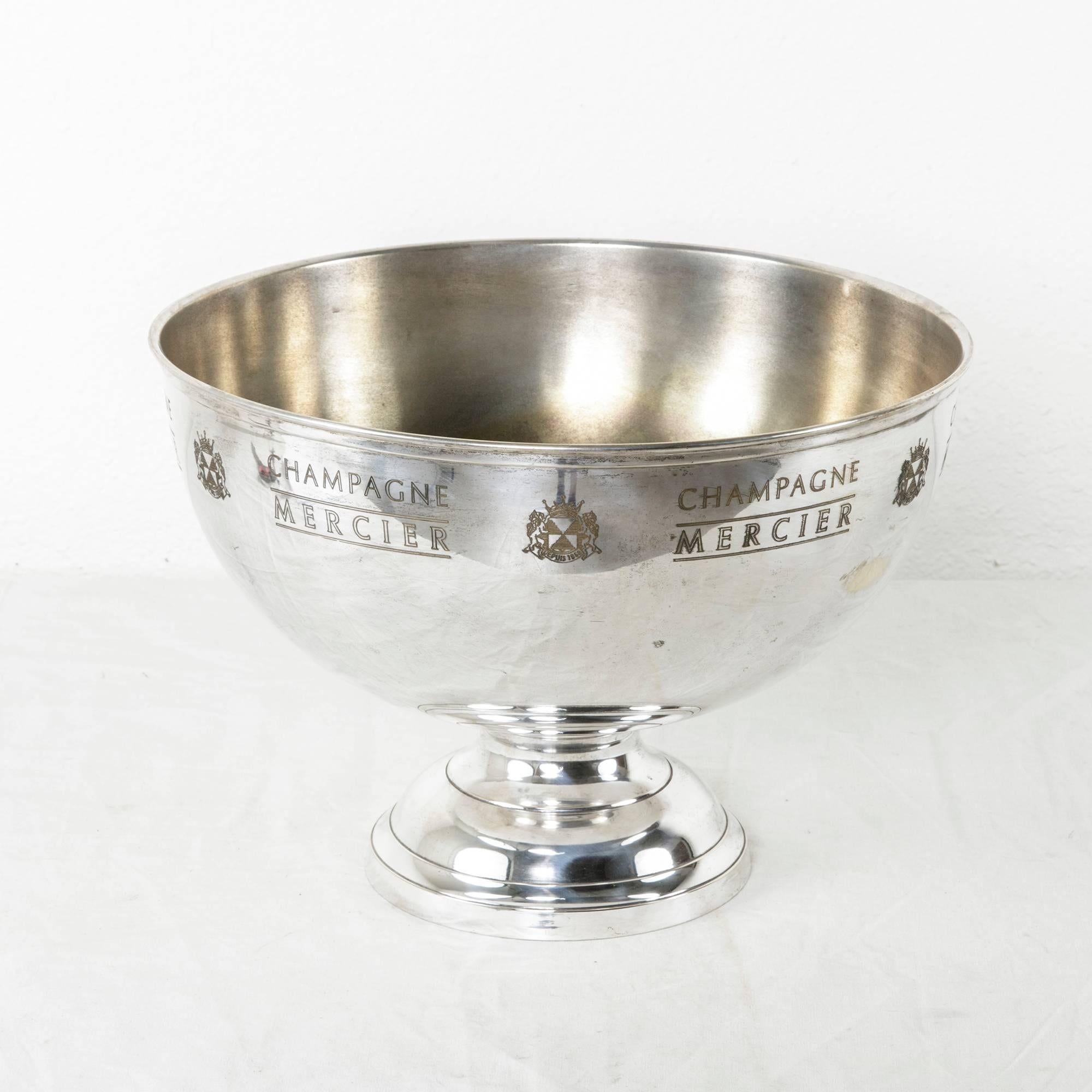 This large hotel champagne bucket is designed to chill up to six bottles at a time and is engraved with the mark of the champagne domain, Mercier. An exquisite bar piece, this silver plate bowl will display beautifully on a sideboard, buffet or