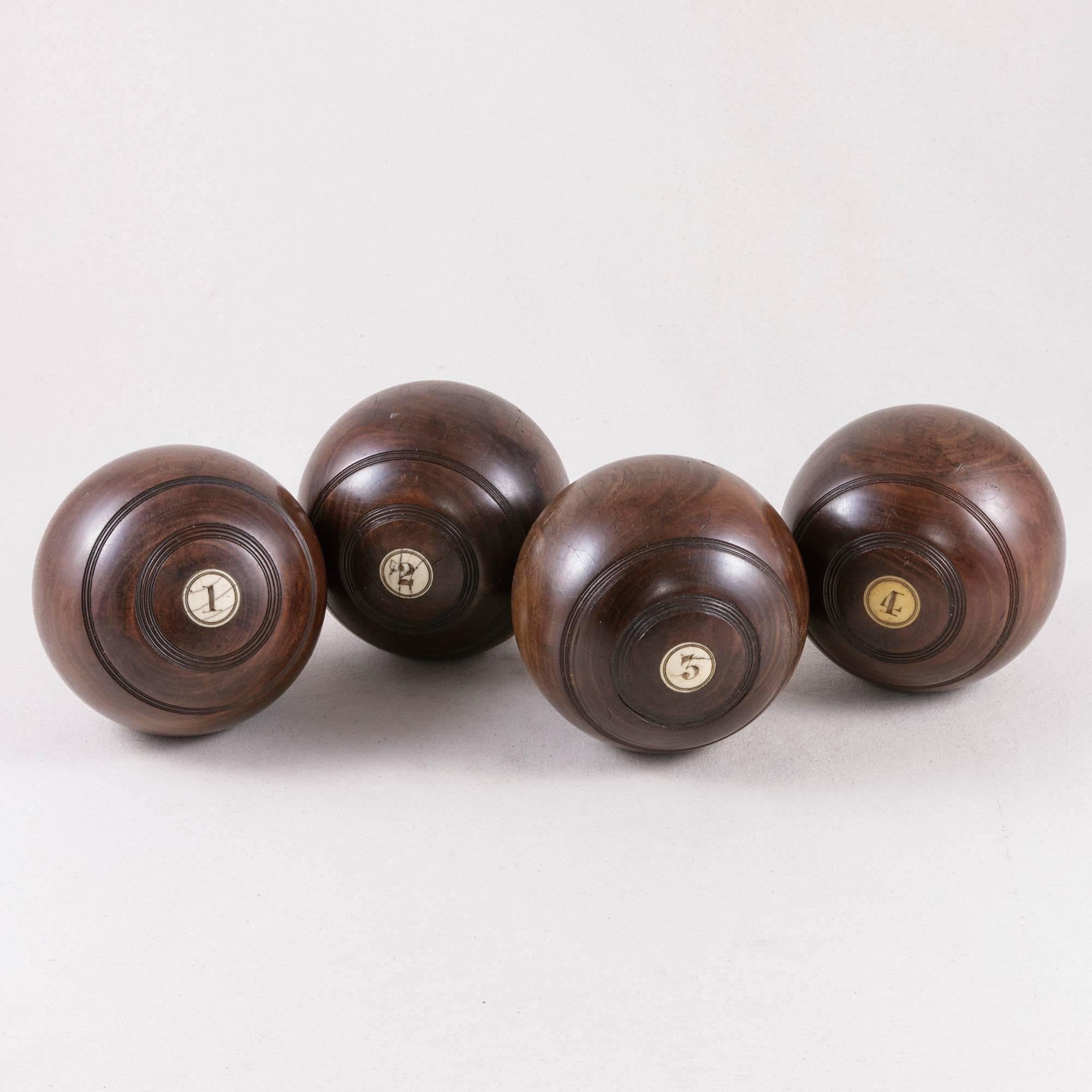 This set of four English lawn balls is made from burled lignum vitae. Imported from South America and known as the 