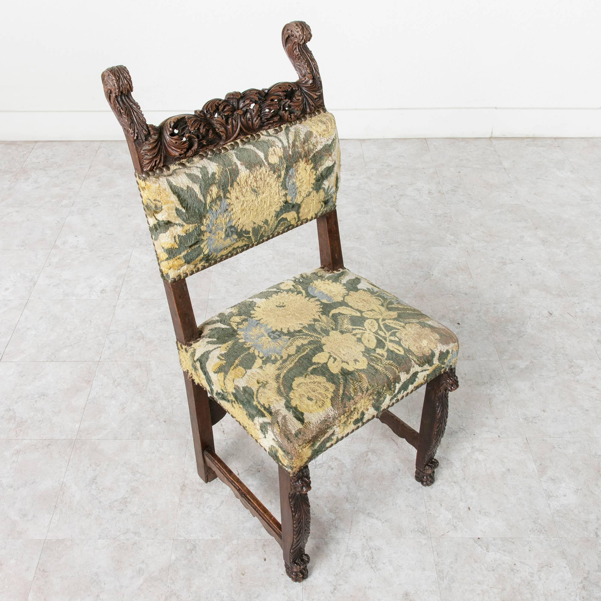 This sumptuously hand-carved walnut Louis XIII style side chair is a truly a rare find. The top rail of the chair features exceptionally deep relief carvings of acanthus leaves. The artistry of the wood carver defies understanding since the three