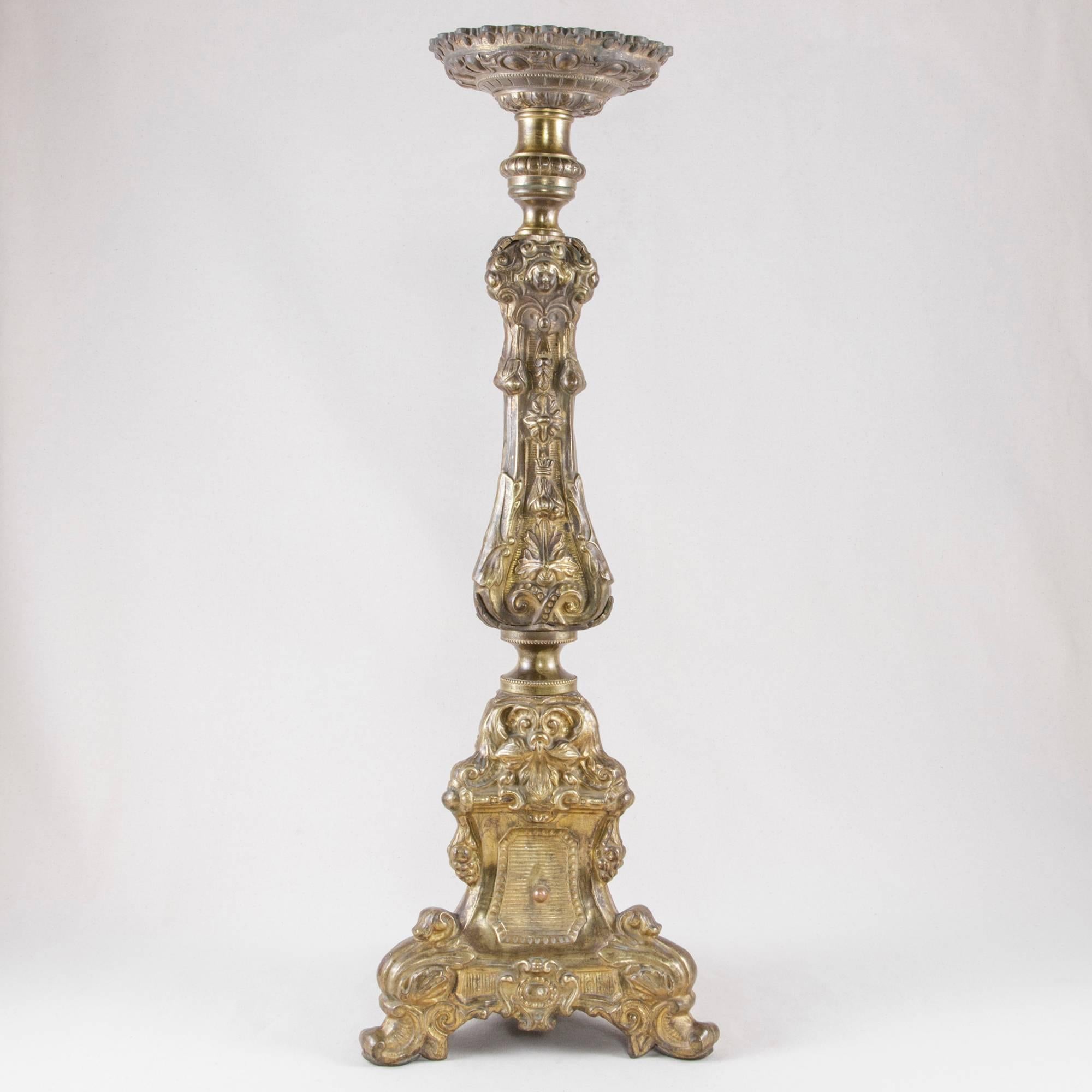 This regal 19th century bronze repousse candlestick in the Louis XV style originally made its home in a private chapel in France. An egg and dart motif encircles its bobeche whose function was to catch dripping candle wax. This pricket, or