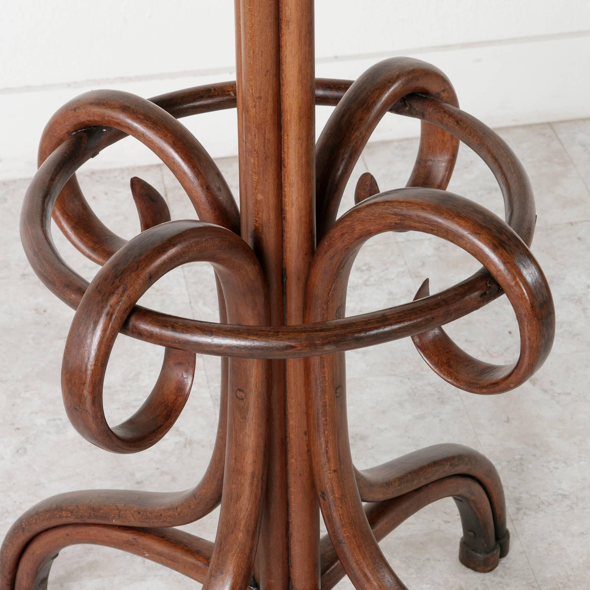 This Classic Thonet style hat and coat rack is made of richly finished bent beechwood. A familiar fixture in the early 20th century French bistro, this piece will bring a handsome touch to any entry or dressing space or to your own French café,