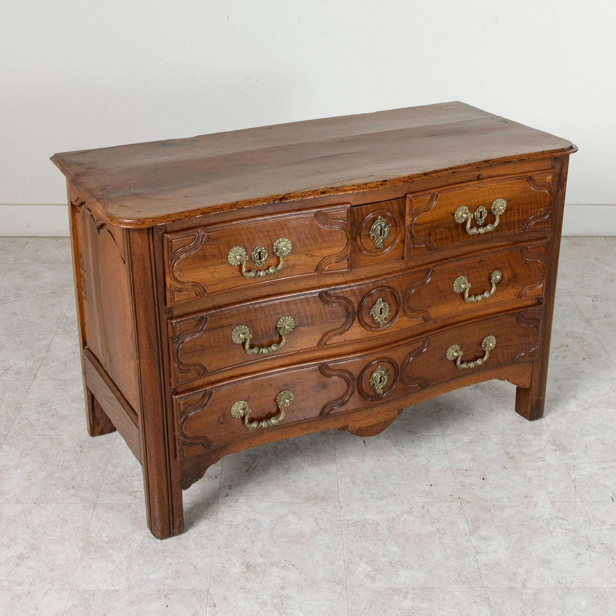 A magnificent French antique hand-carved walnut chest of drawers stamped by the cabinet maker, Jean-Baptiste Fromageau (b. 1726). Fromageau became a master ebenist in 1755 and later established his atelier on the famous Rue du Faubourg Saint-Antoine