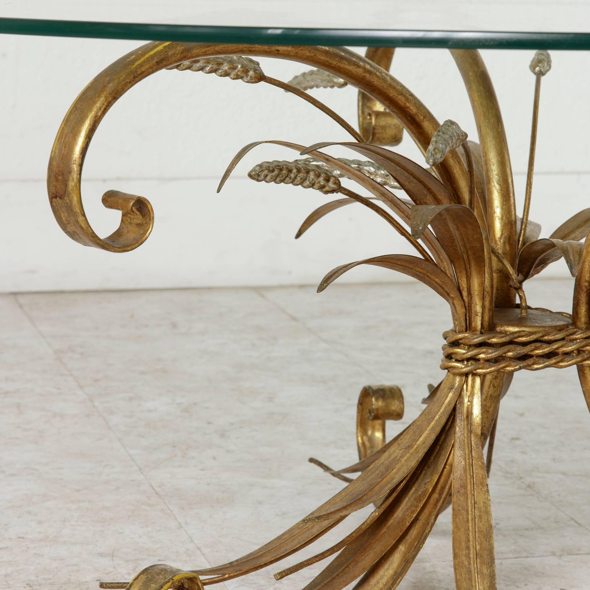 Attributed to Maison Baguès, this classic mid-century piece has become the iconic Coco Chanel coffee table. Gilded sheaves of wheat bound together by twisted cord of gilt metal and accented with silver detailing support its original glass top. This