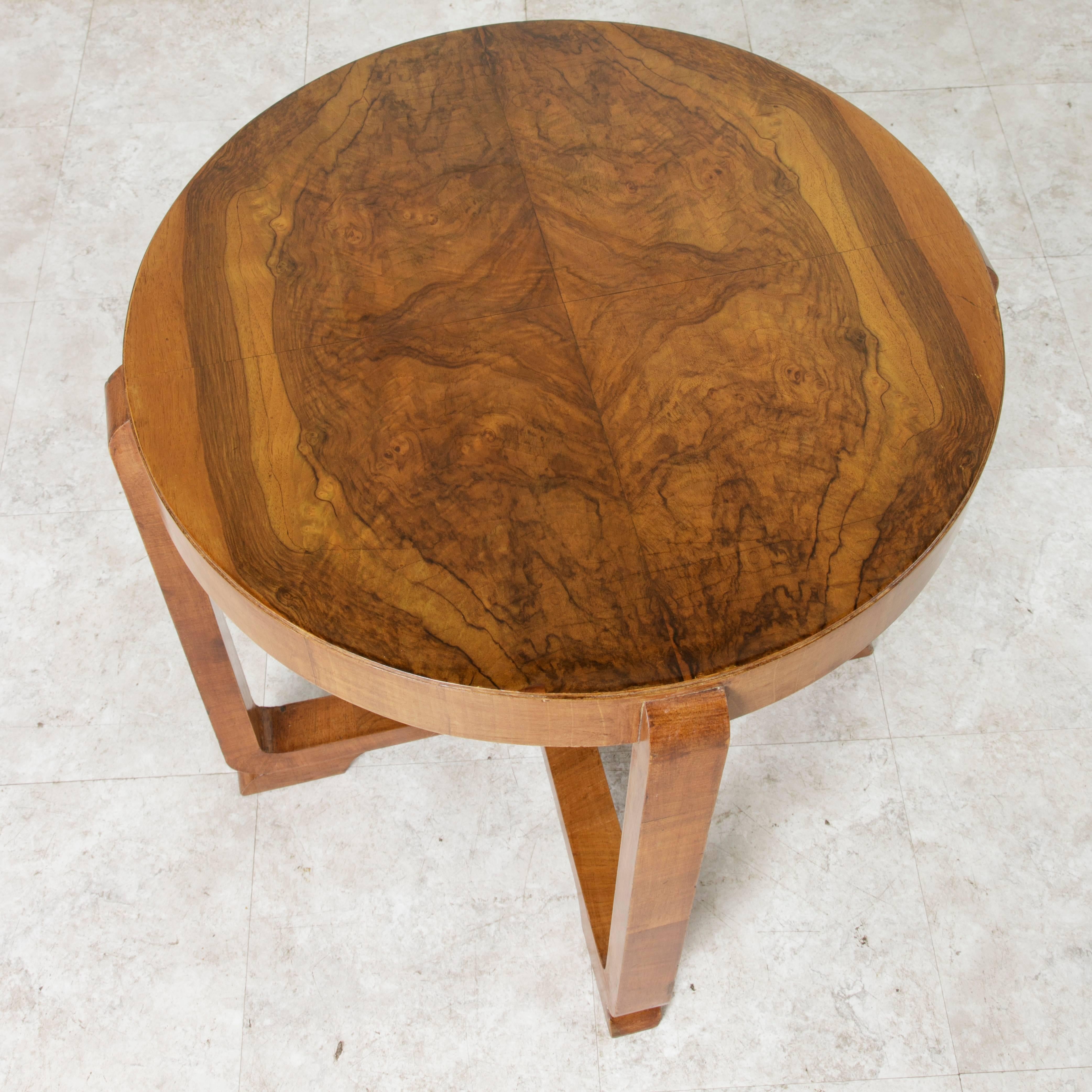 With simple lines that allow for appreciation of the magnificent bookmatched burl walnut top, this French Art Deco period side table is finely finished with a French polish. An exceptional piece to lend its chic style beside a chair or as a cocktail