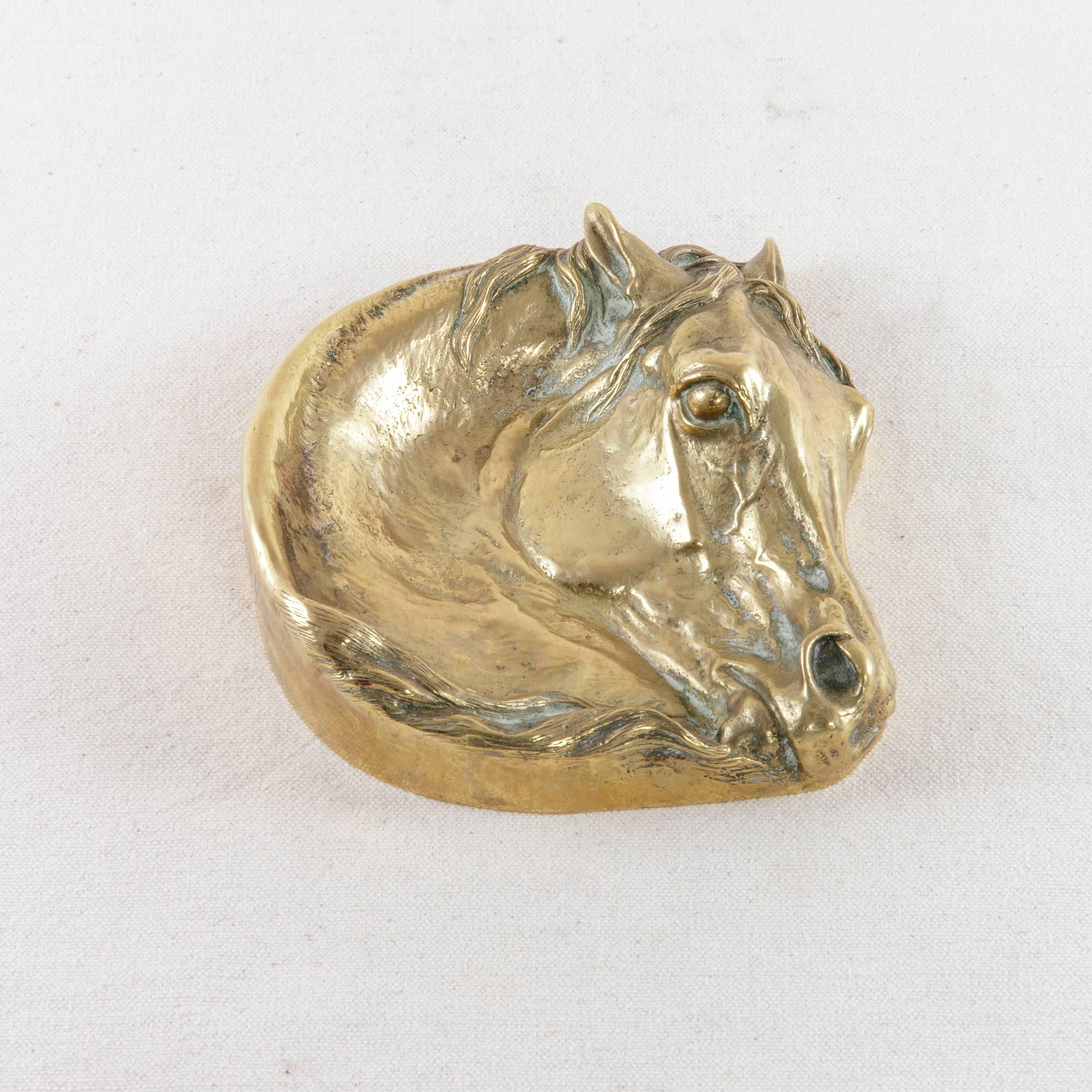 This bronze vide poche, or empty-your-pockets dish, in the shape of a horse's head is signed in Cyrillic letters, E. Lancere. Attributed to the Russian artist, Evgeni Aleksandrovich Lancere (1848-1886), who was a master of sculpture and specialized