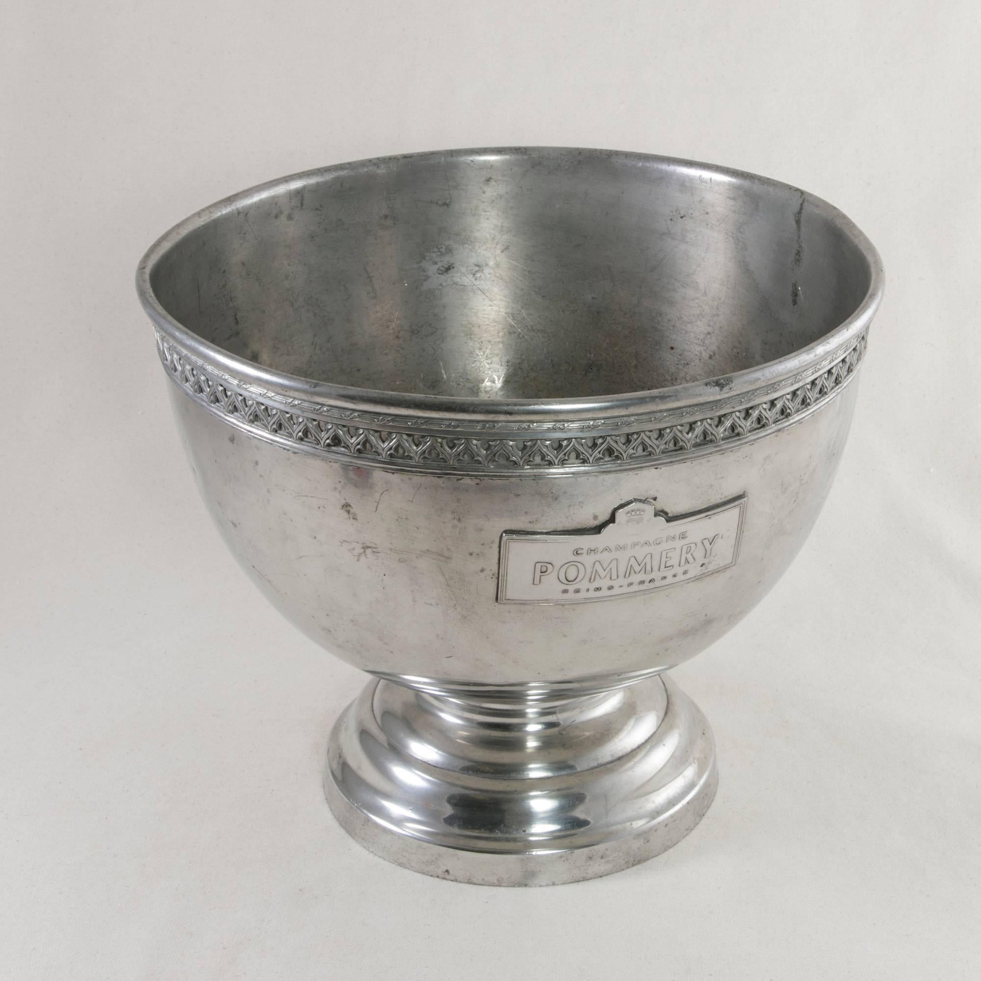 This large pewter hotel champagne bucket was originally used in a Paris bistro around the turn of the century. It is marked on both sides with the label of Pommery, one of the largest champagne houses in France, as well as with the name of the