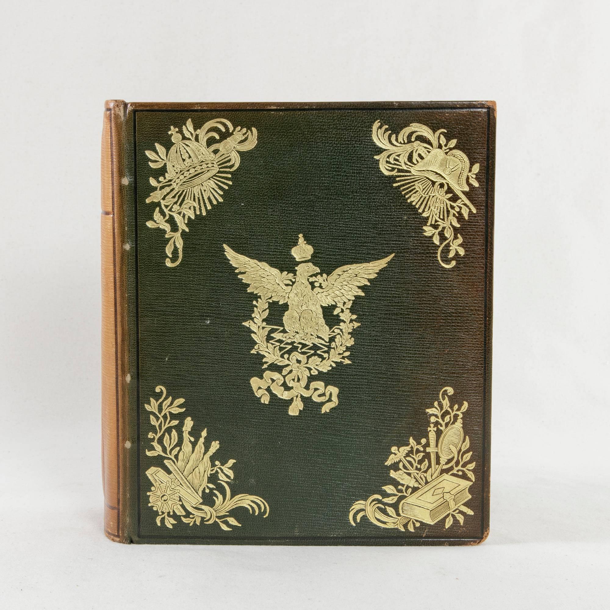 A chronicle of the feats of Napoleon Bonaparte and his Imperial Guard, this mid-20th century leather bound book written in French features a green leather front and back with a cognac colored leather spine. This volume is ornately gold tooled with