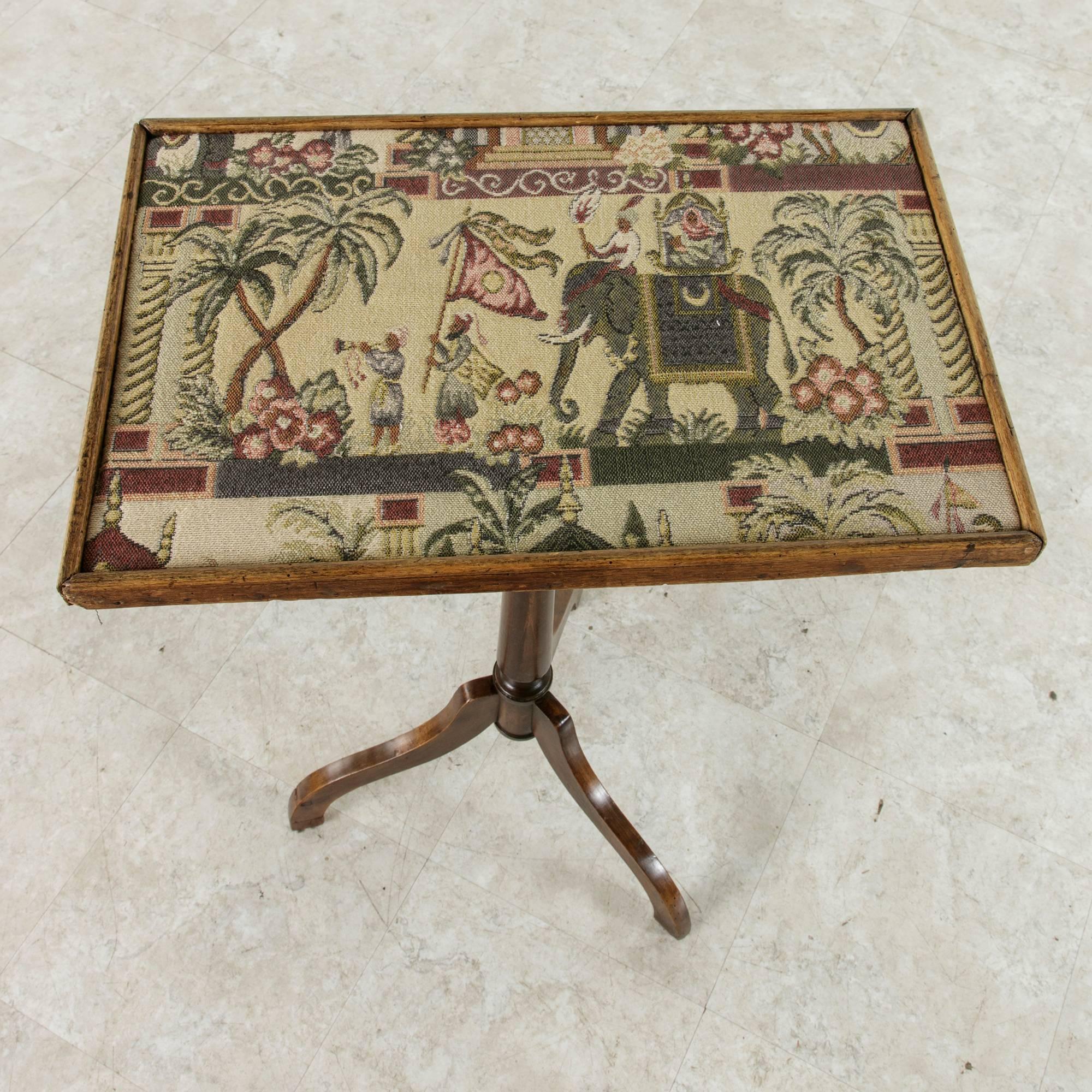 This Louis Philippe period walnut tripod table is finished with a tapestry top. A royal procession is presented with a standard bearer leading the elephant of an Indian prince. An ideal small-scaled side table to place beside a chair, circa