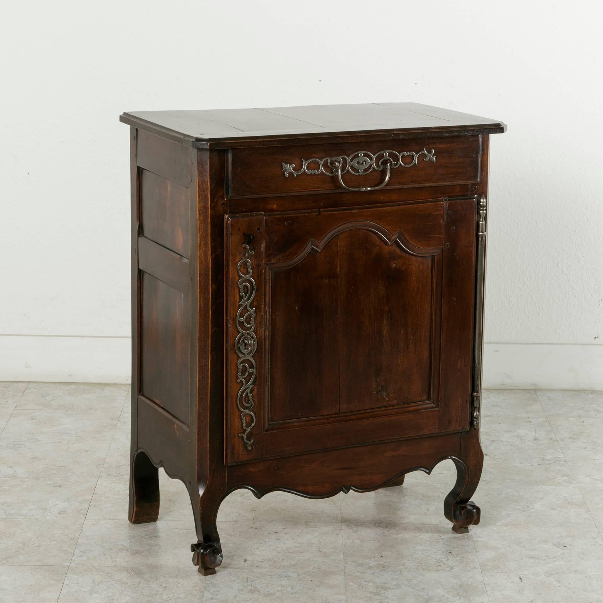 Originally from the region of Normandy, France, this late 19th century cherrywood cabinet features a hand pegged frame and solid paneled sides that rest on Louis XV style escargot feet. Its function was to store home-made jambs. With a beveled edge