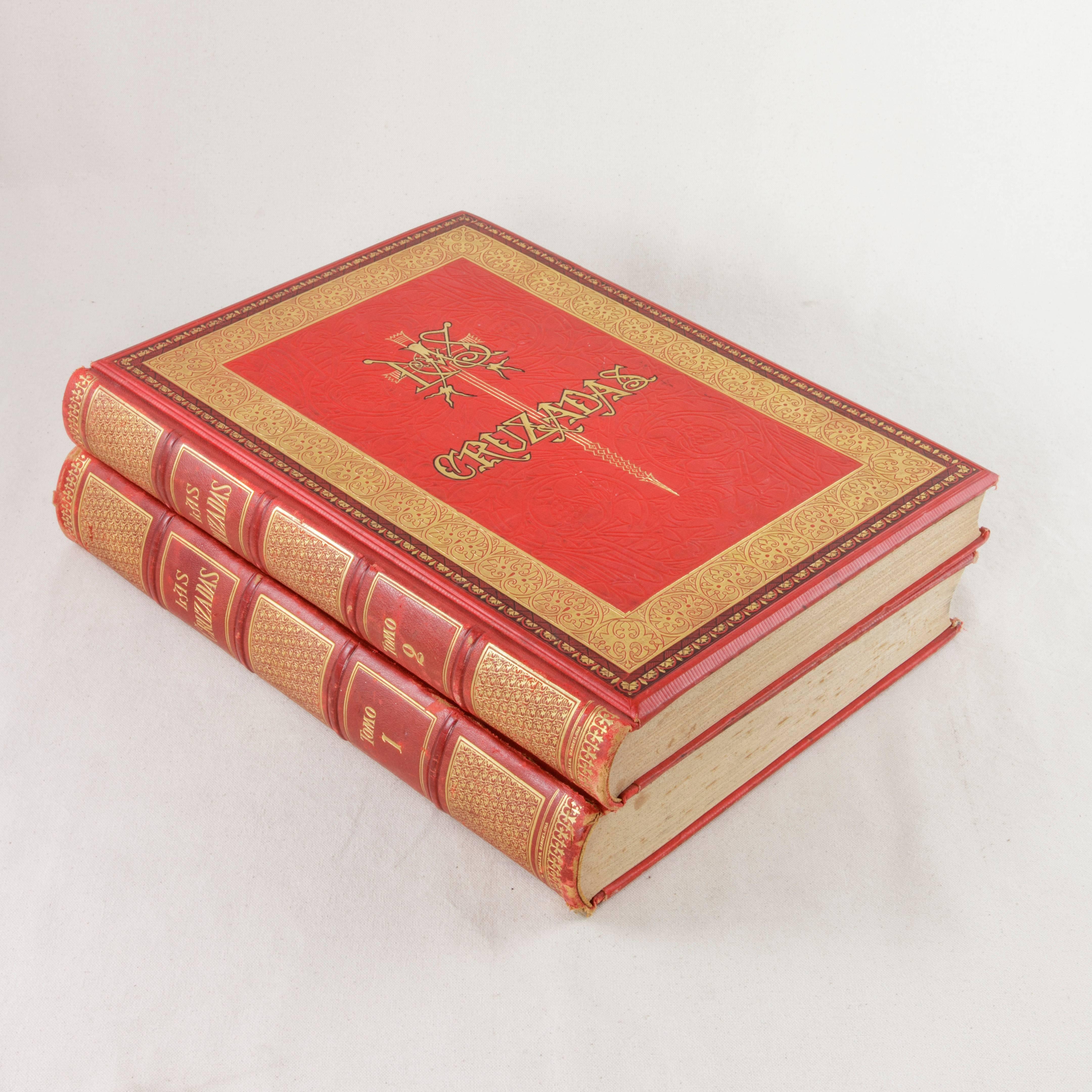 This large pair of red leather books from the late 19th century features gold tooling around the borders of the cover as well as a central cross. Entitled Las Cruzadas and written in Spanish, this two volume set chronicles the history of the