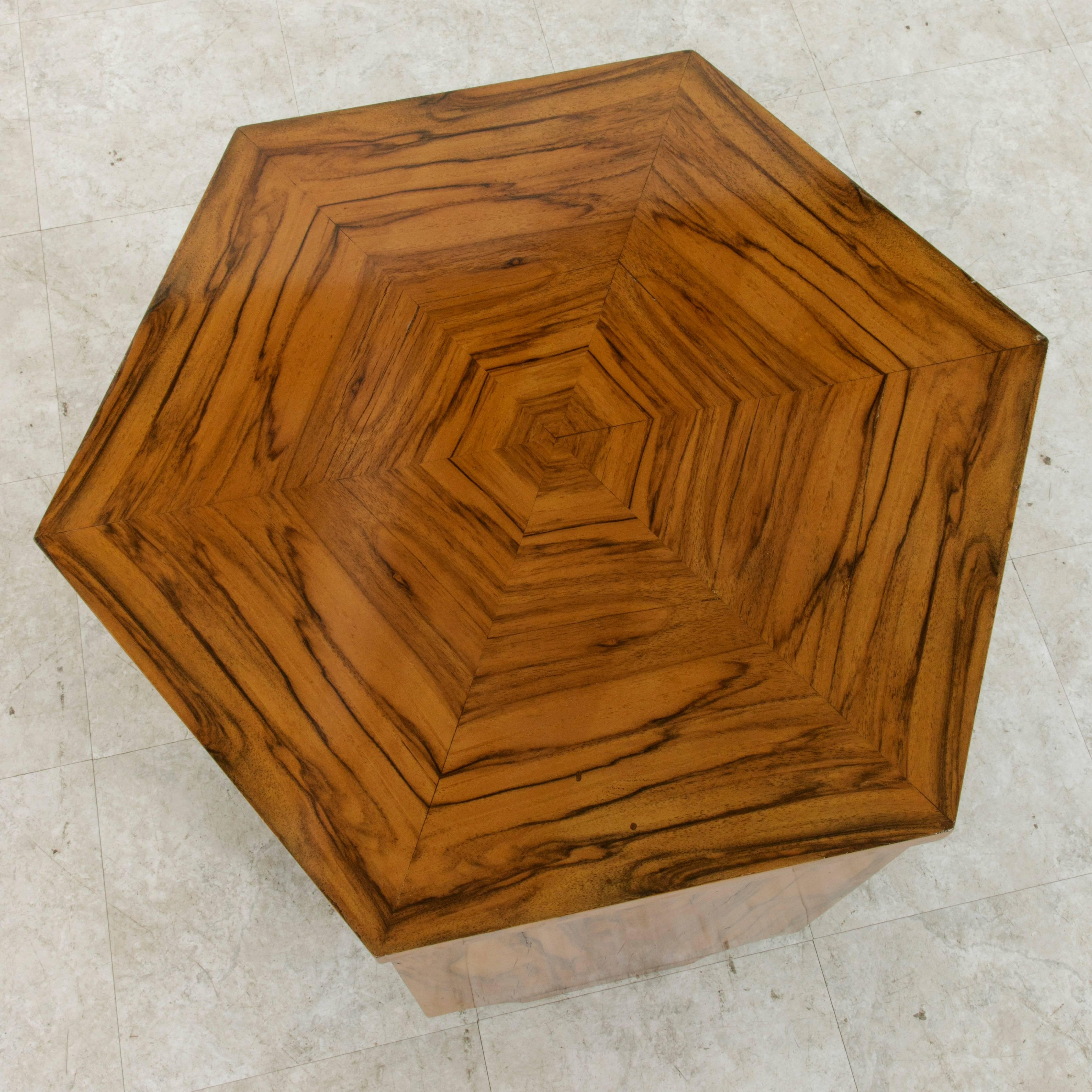 Hexagonal in form, this stunning French side table or end table from the Art Deco period features a book matched burled walnut top and sides. A lower book matched shelf allows for additional display space. Open on three sides and finished all