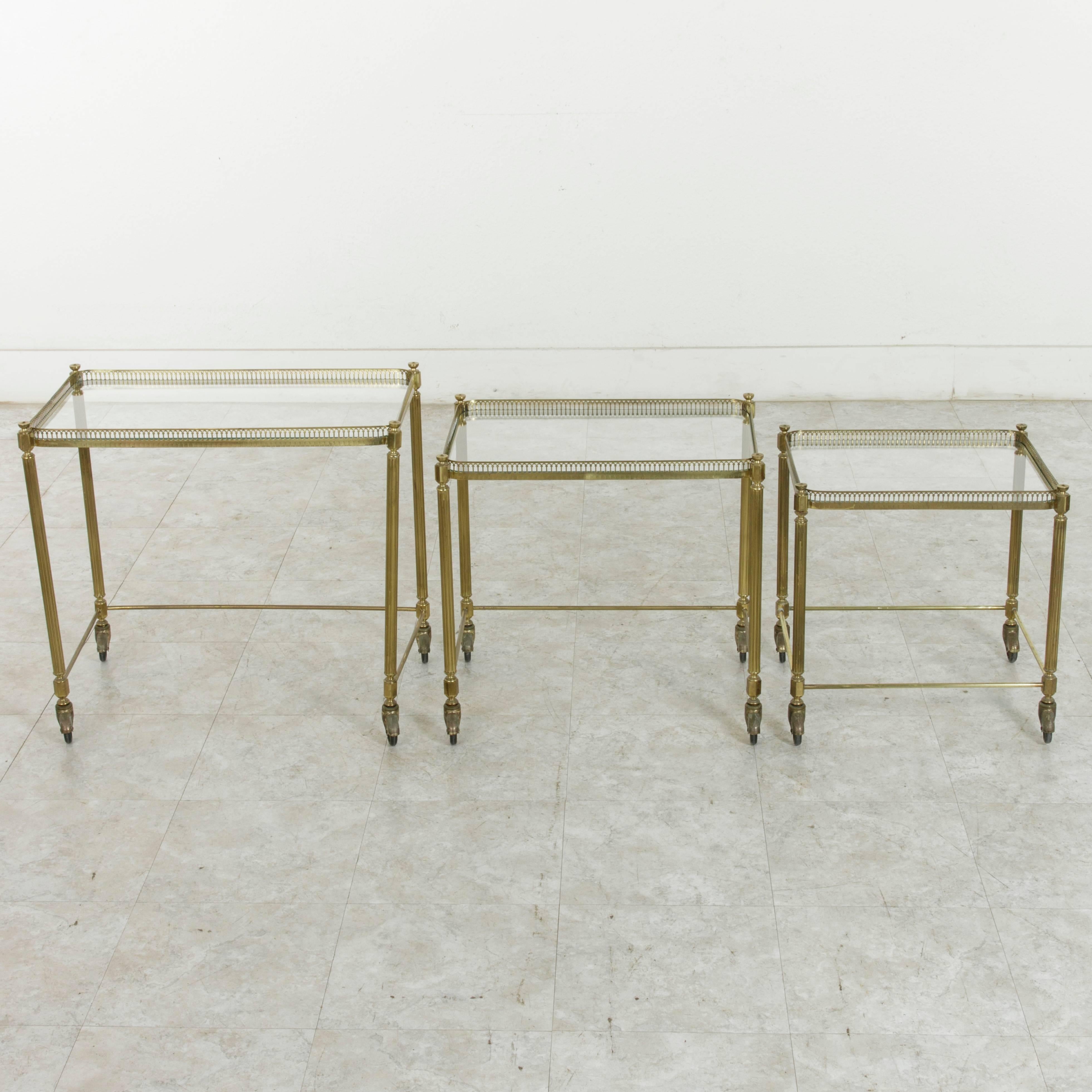 Set of Three Midcentury French Brass and Glass Nesting Tables on Casters 1