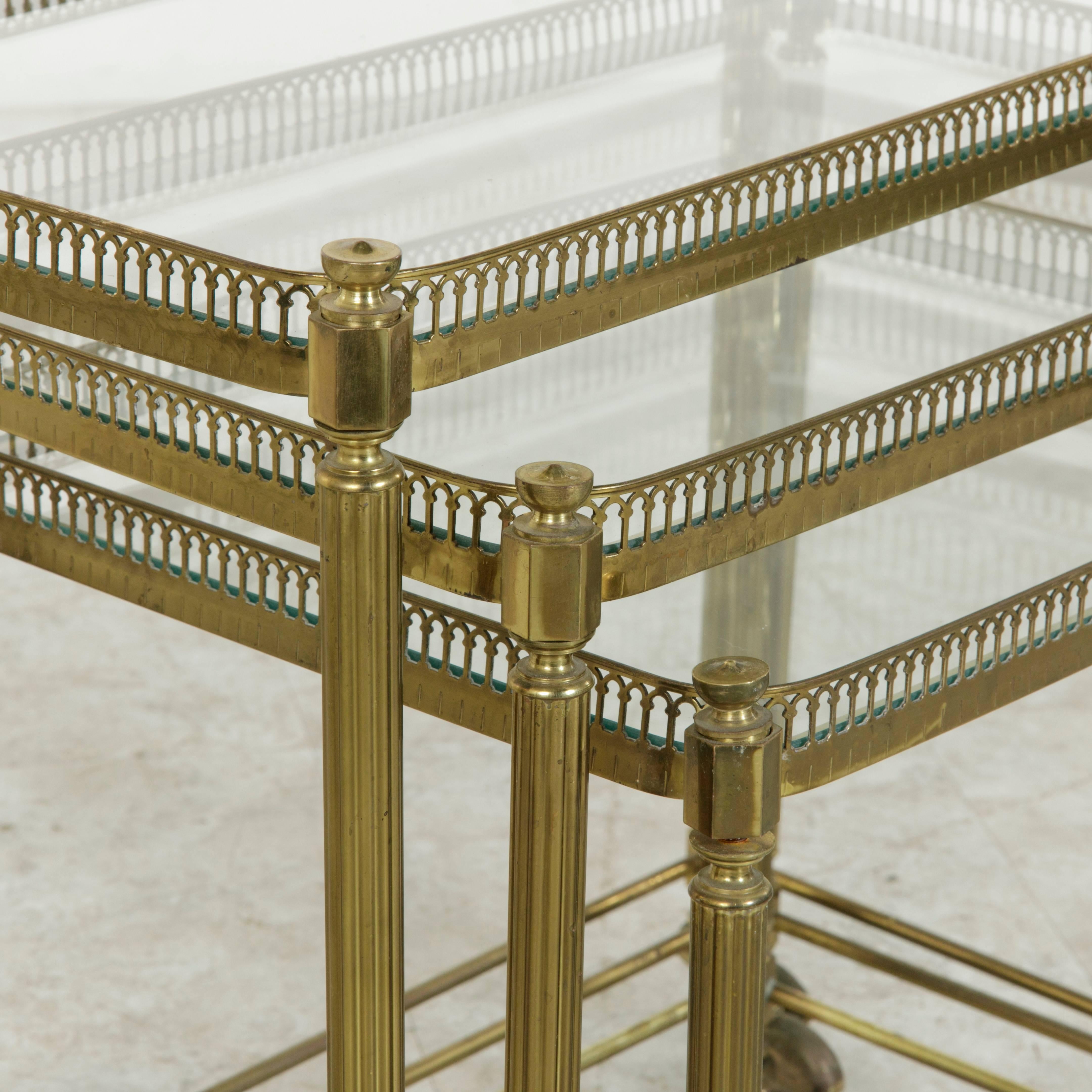 Set of Three Midcentury French Brass and Glass Nesting Tables on Casters In Excellent Condition In Fayetteville, AR