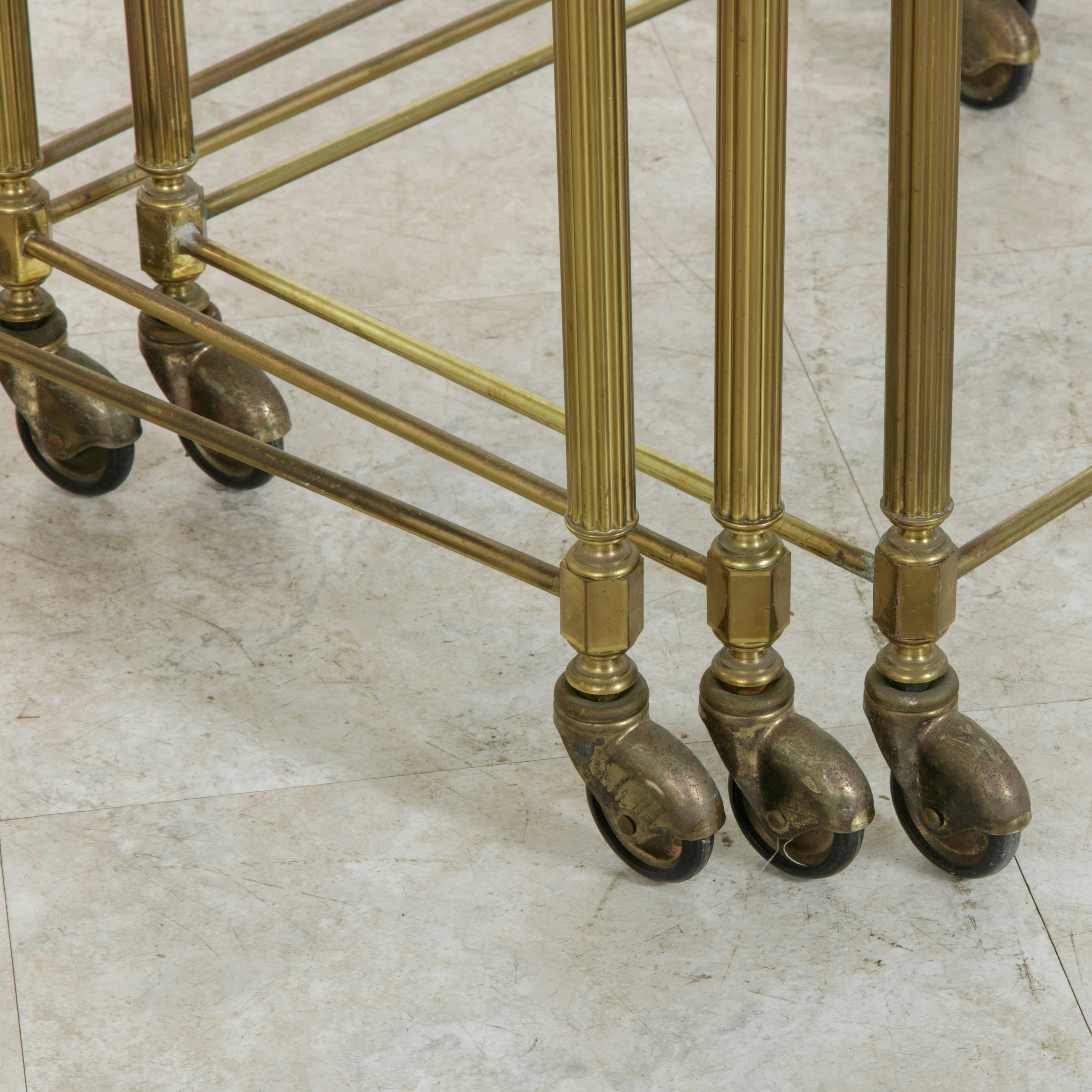 20th Century Set of Three Midcentury French Brass and Glass Nesting Tables on Casters