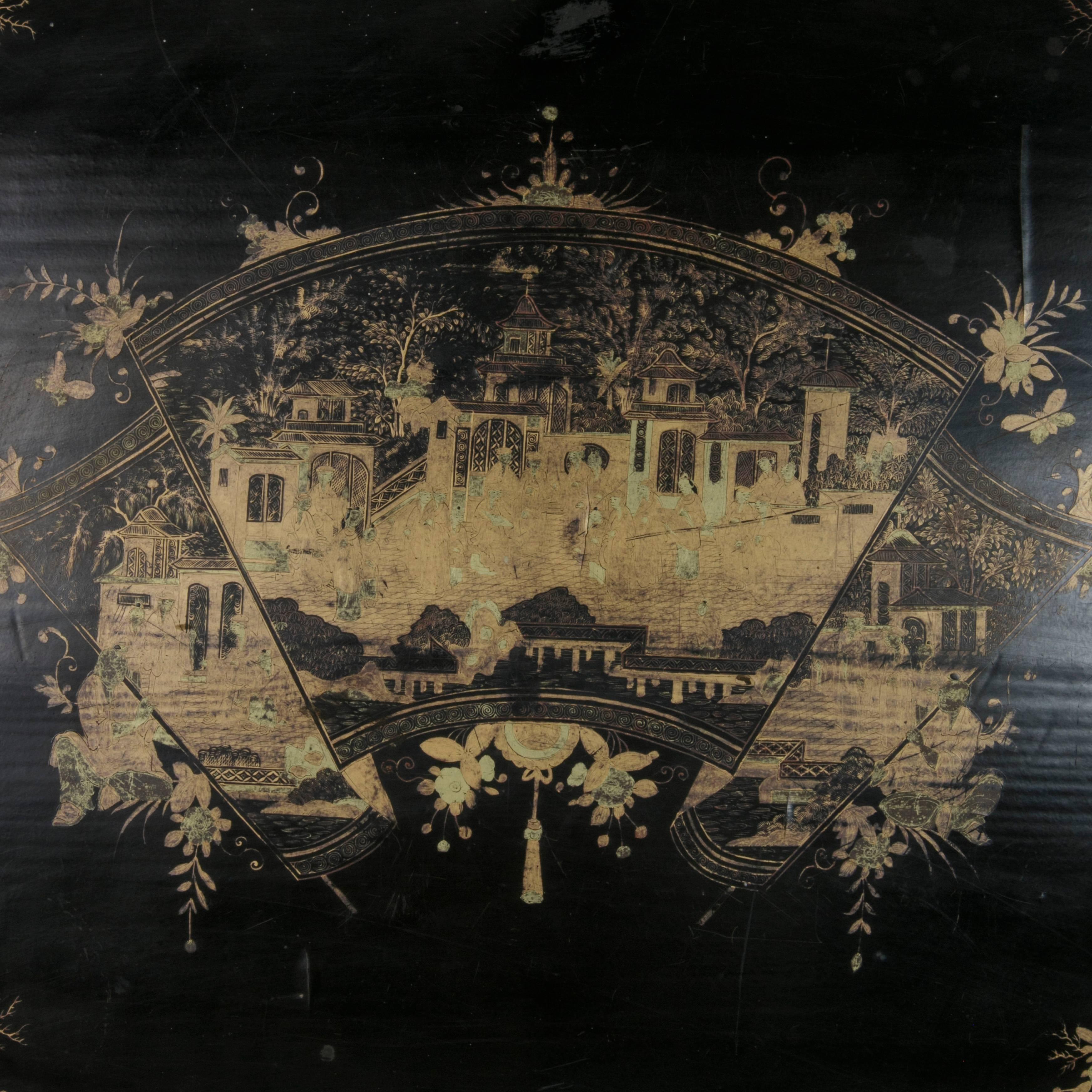 Found in France, this very large 19th century black lacquer wooden tray dates to the period of Napoleon III,  An ornately hand painted scene in gold chinoiserie features a grand procession in front of an imperial palace displayed on an unfurling