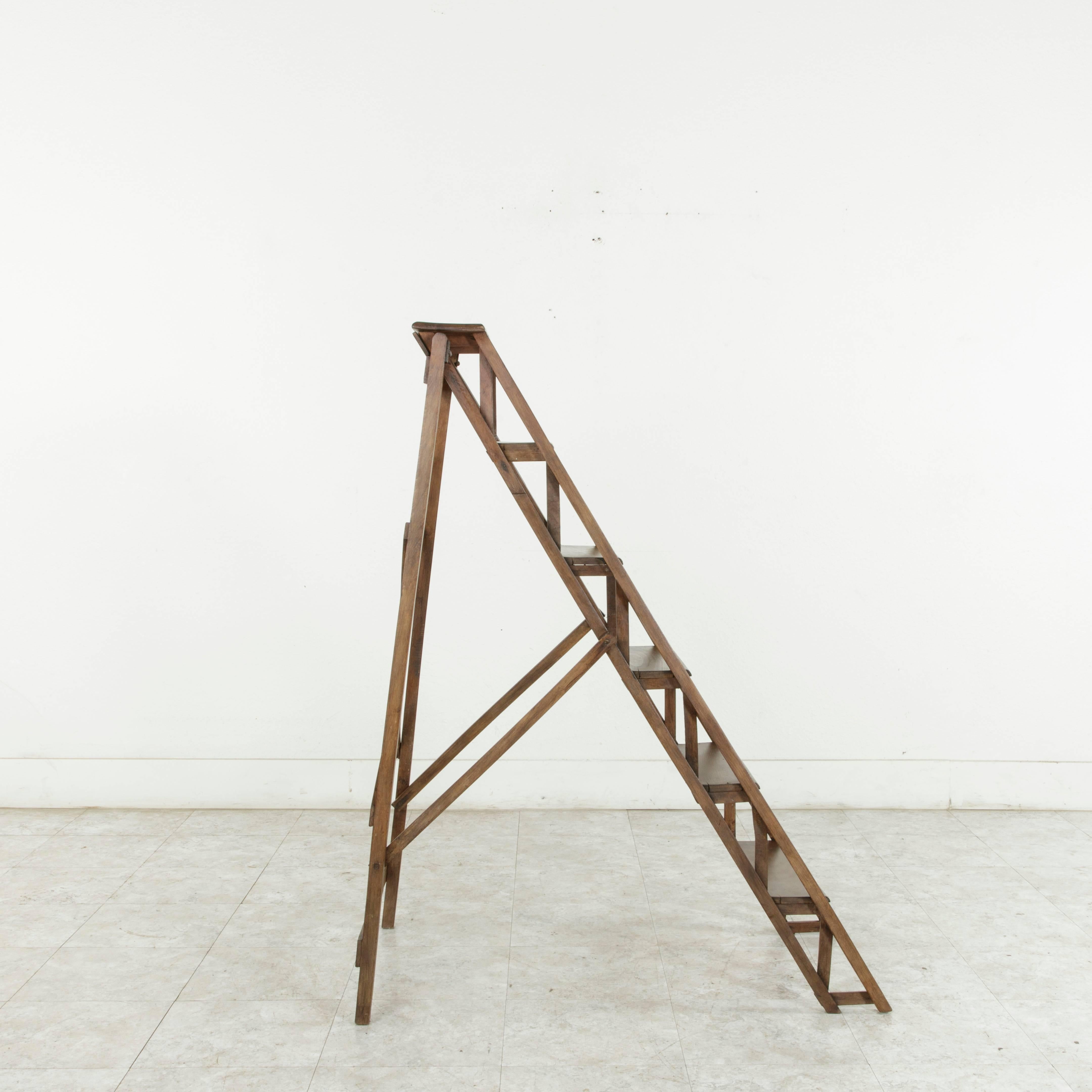 Originally used in a French library, this folding ladder constructed of ash would be a handsome addition to any space with hard to reach shelving. While still being utilitarian, this ladder also maintains an artistic presence that allows its six