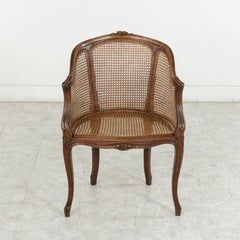 Early 20th Century French Louis XV Style Hand-Carved Oak and Caned Bergere