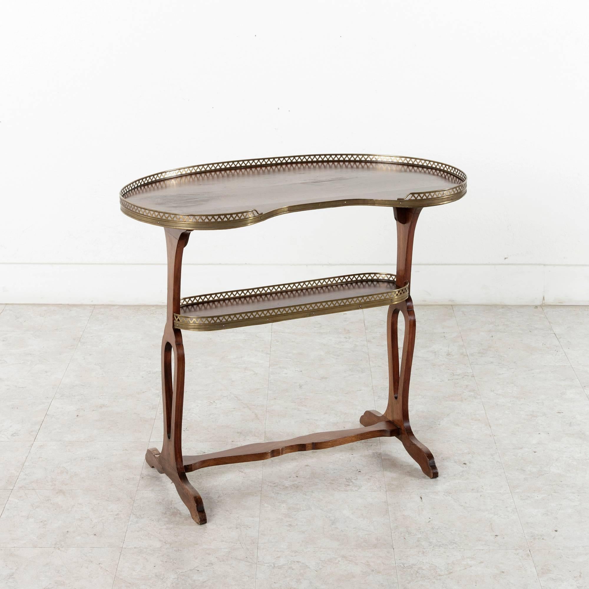 This Restauration period mahogany kidney shaped side table has simple, elegant curves and bronze galleries. Create circa 1820, this piece is of an excellent scale to hold a petite laptop or Ipad or or as a bar table.