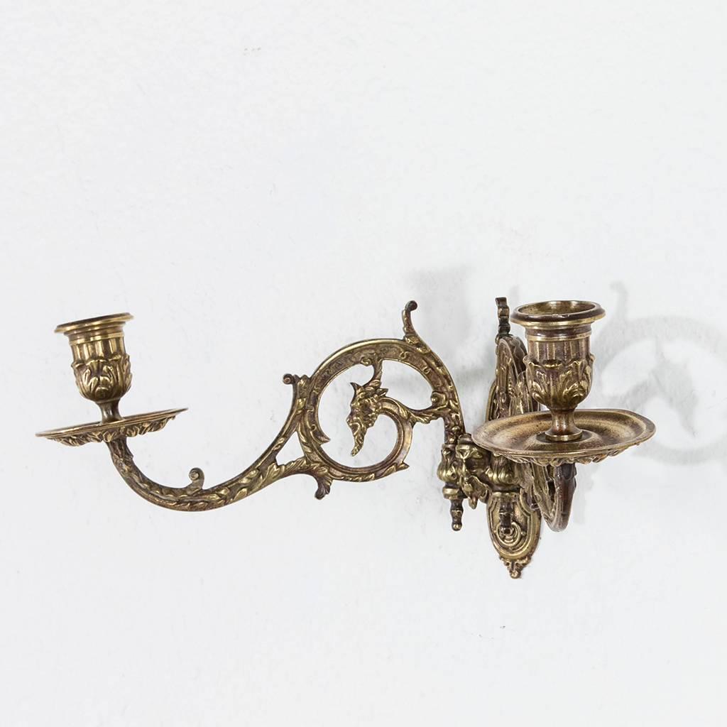 This finely detailed pair of 19th century French bronze sconces was originally mounted on a piano to light music. Because of this purpose, the arms on each are designed to swivel left and right. Each one features scrolling acanthus leaves and the