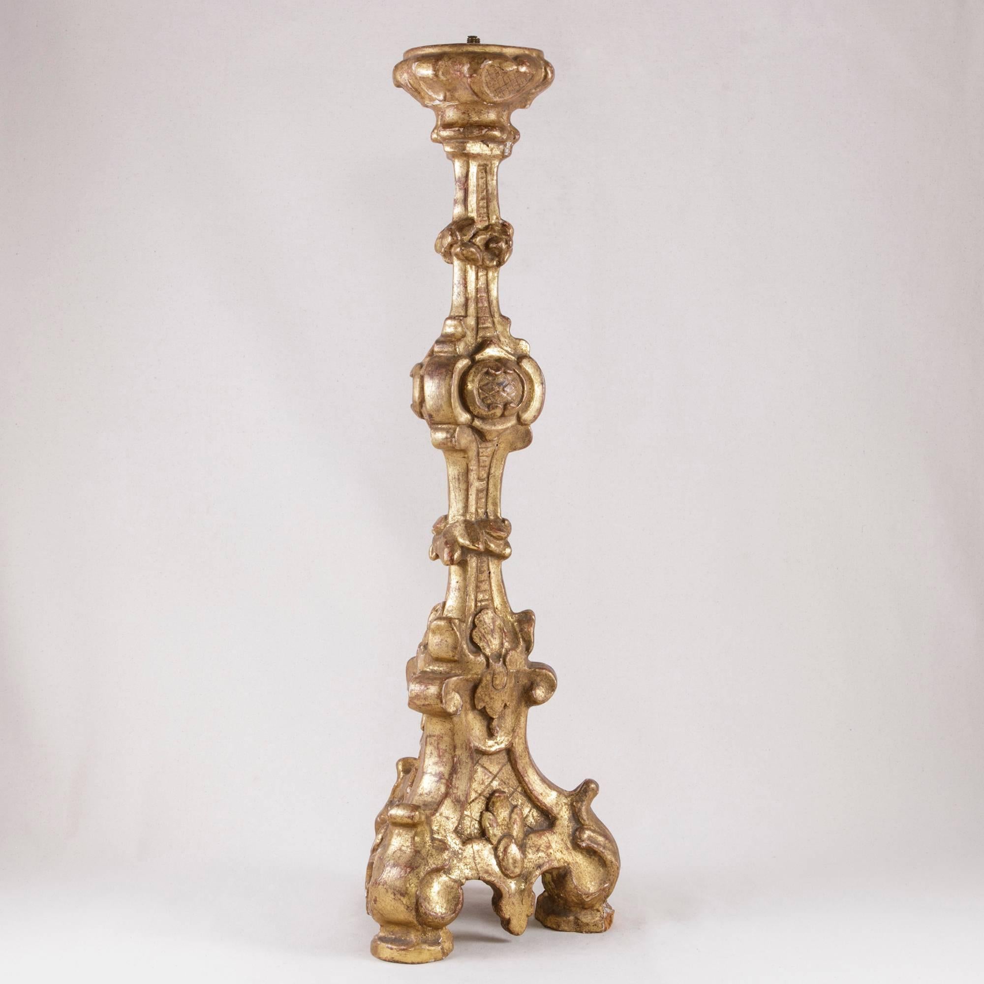 From Piedmont, Italy, this eighteenth century hand-carved giltwood pic-cierge or pricket was originally used in a chapel. This piece features a foliage baluster stem on a tripod base. This candlestick can hold a 3-inch diameter candle. An authentic