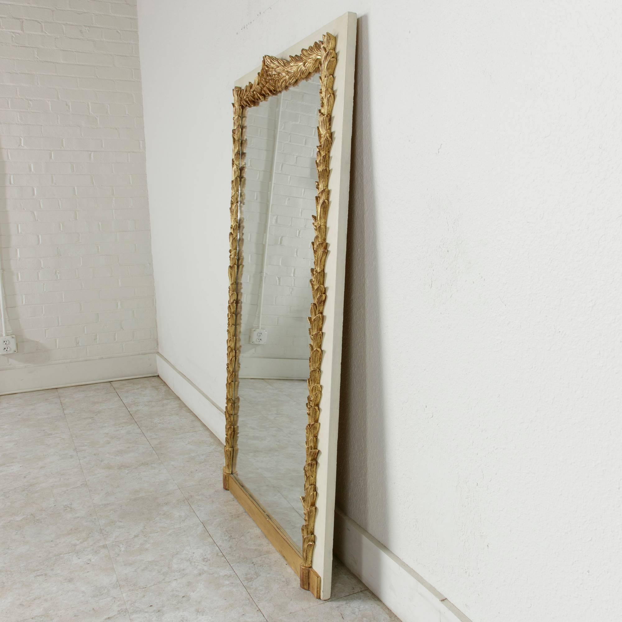 This grand late 19th century painted mantel mirror was originally part of a boiseries in a home in Versailles. Adorned with giltwood garlands of laurel, its elegant simplicity will blend beautifully in both traditional and contemporary settings.