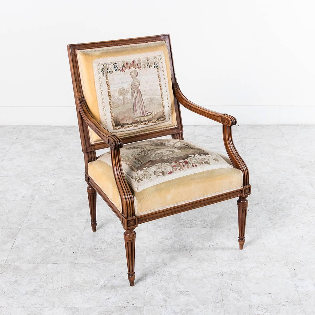 This pair of c. 1880 hand carved walnut Louis XVI style armchairs are upholstered in a pale yellow velvet with four antique panels of early nineteenth century Gobelins petit point tapestry.  Modern interiors will find handsome companions in this