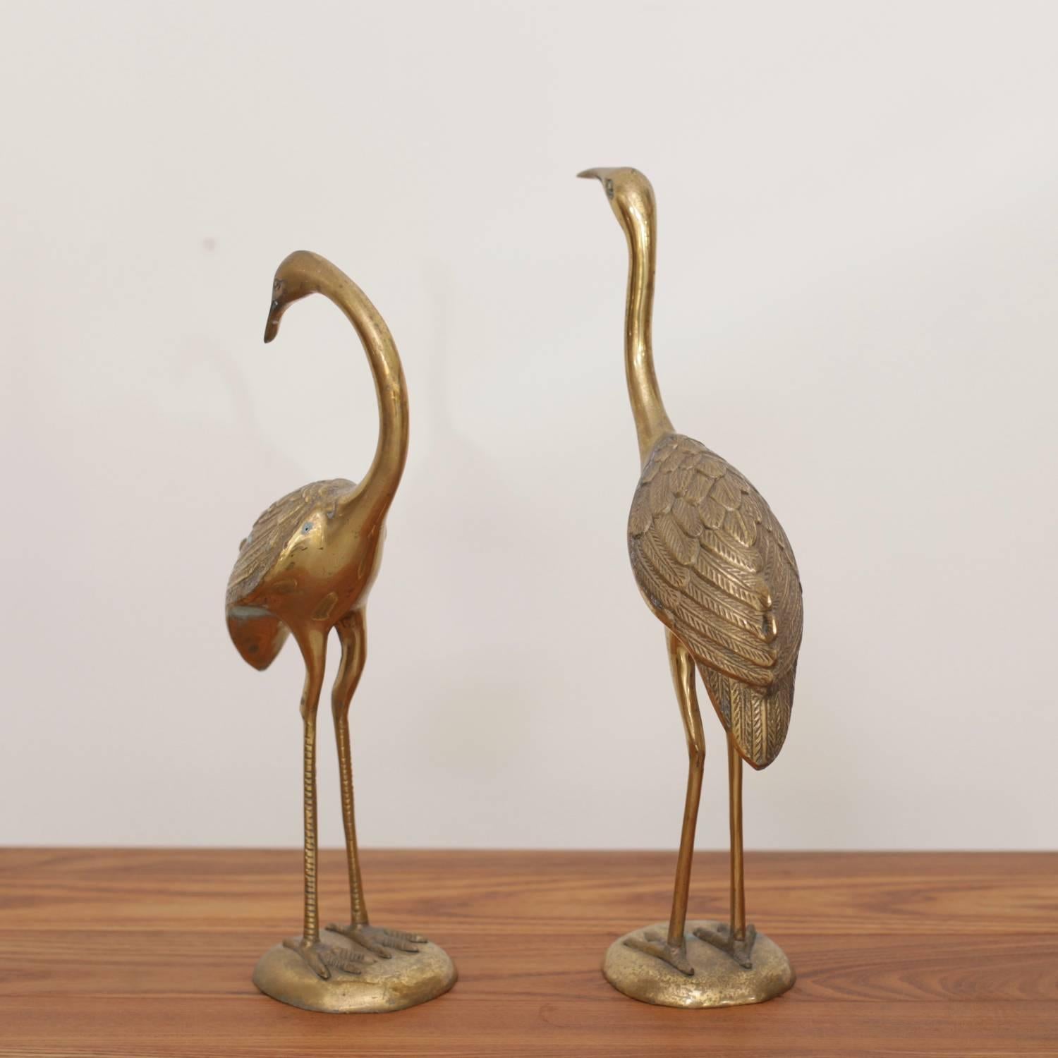 Beautiful pair of flamingos or cranes made of brass. They are in very good condition and they bring the Hollywood Regency glamour in every room.

