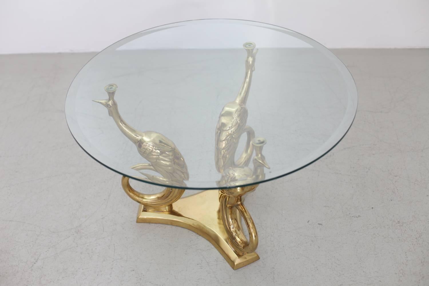 Very elegant coffee or side table in brass and glass. The glass tabletop is holded by three peacocks. The table is a really eyecatcher. The same table in an other form is also listed.