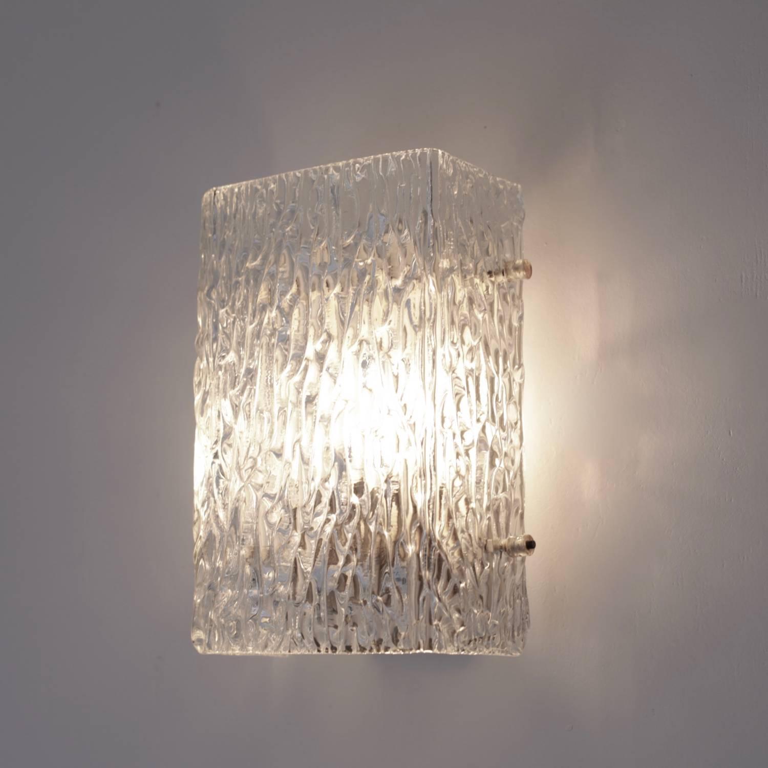 Beautiful glass sconces or wall lights from the 1960s produced by the high end glass manufacturer Kalmar. The thick textured glass creates a wonderful light effect. The sconces are in excellent condition and matching sconces in other size also