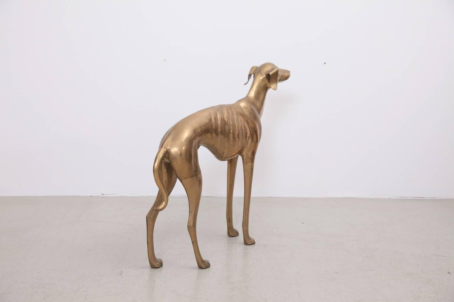 Extraordinary huge dog or greyhound made of brass. It's in very good condition and it brings the Hollywood Regency glamour in every room.

