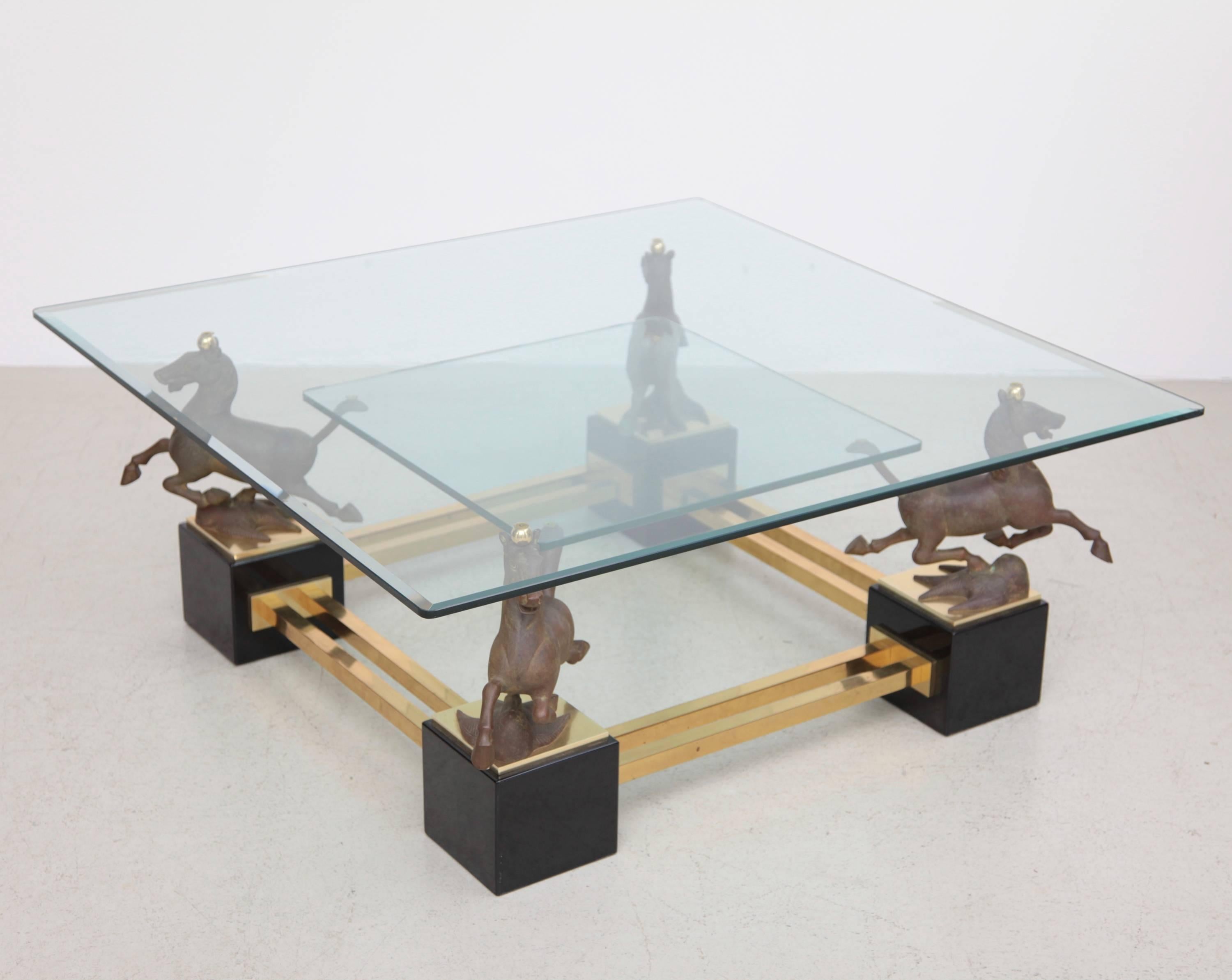Very nice and huge square-shape coffee table with four flying horses of Gansu. The two level table is produced in the 1970s by high end manufacturer Maison Charles. Glass has one small chip on the corner.