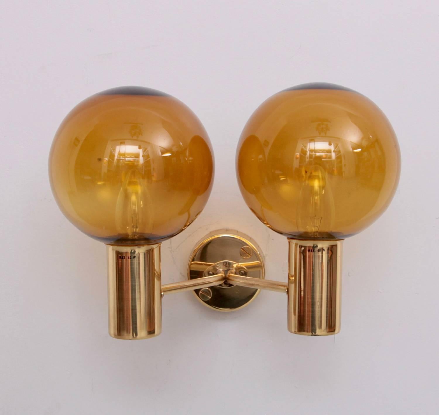 Rare set of two wall lamps model V149/2 Patricia designed by Hans-Agne Jakobsson. Produced by Hans-Agne Jakobsson AB in Markaryd, Sweden. Glass is amber and the wall-mounted brass part has some cracks which is not disturbing when mounted. Two x E14