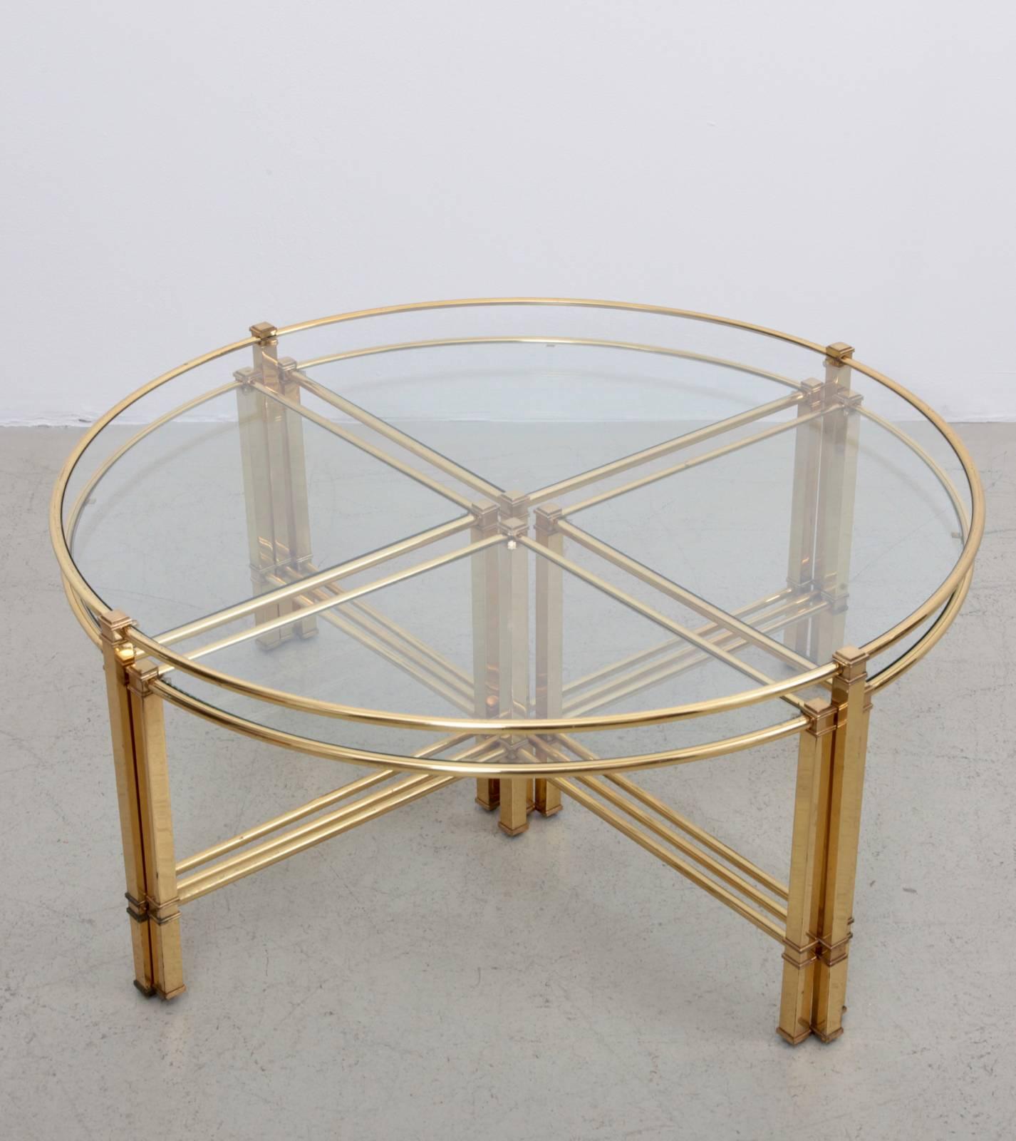 Beautiful round coffee table with four nesting tables in brass by Maison Charles. The glass plates are loosely inserted to create the table surfaces. The table is in very good condition.

