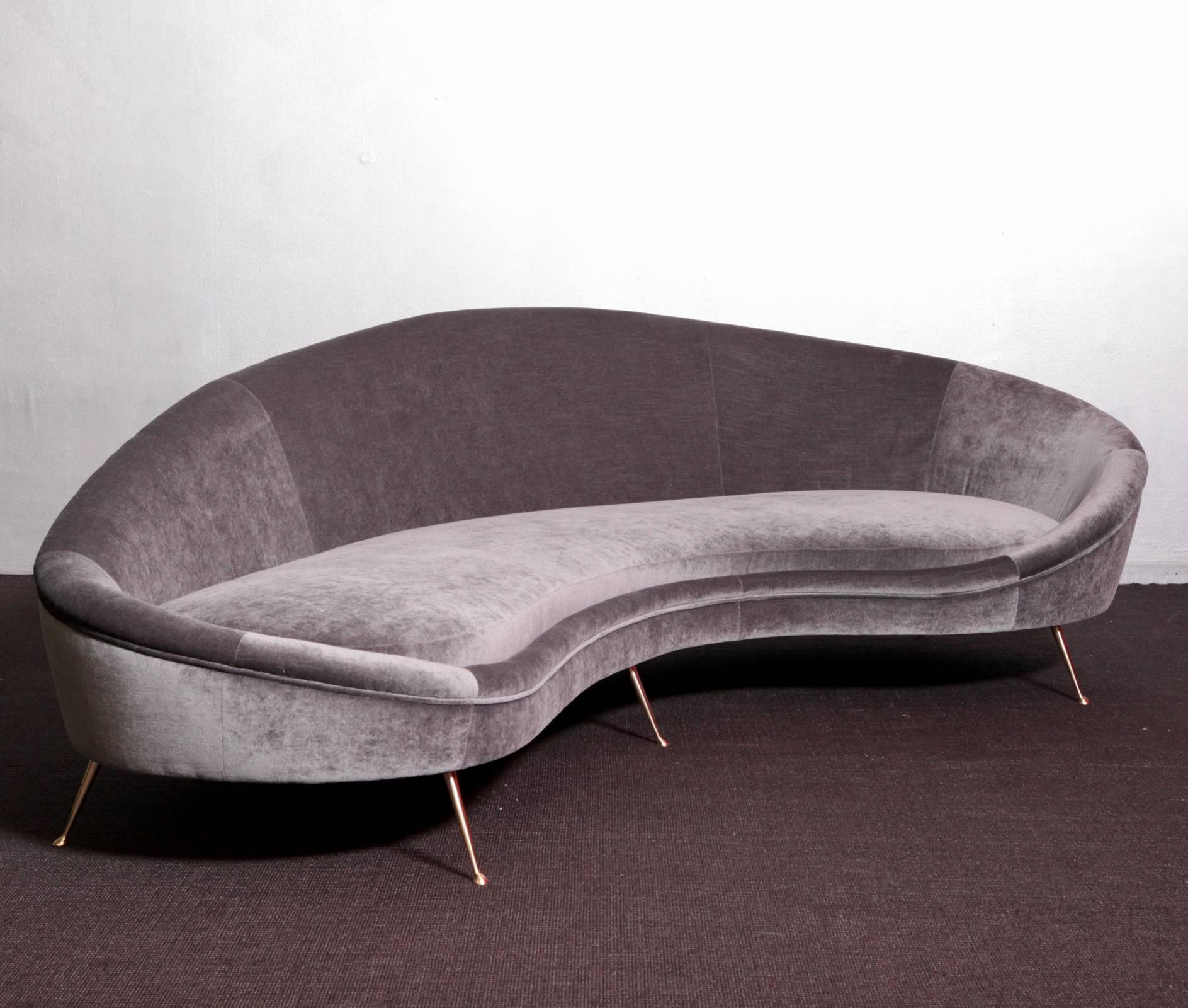 Wonderful huge curved sofa in the manner of Ico Parisi. The sofa is newly upholstered in velvet and it's in a very good condition. The sofa is a real eye catcher in each living room or lobby. The upholstery ist done hard so you don't bog in the
