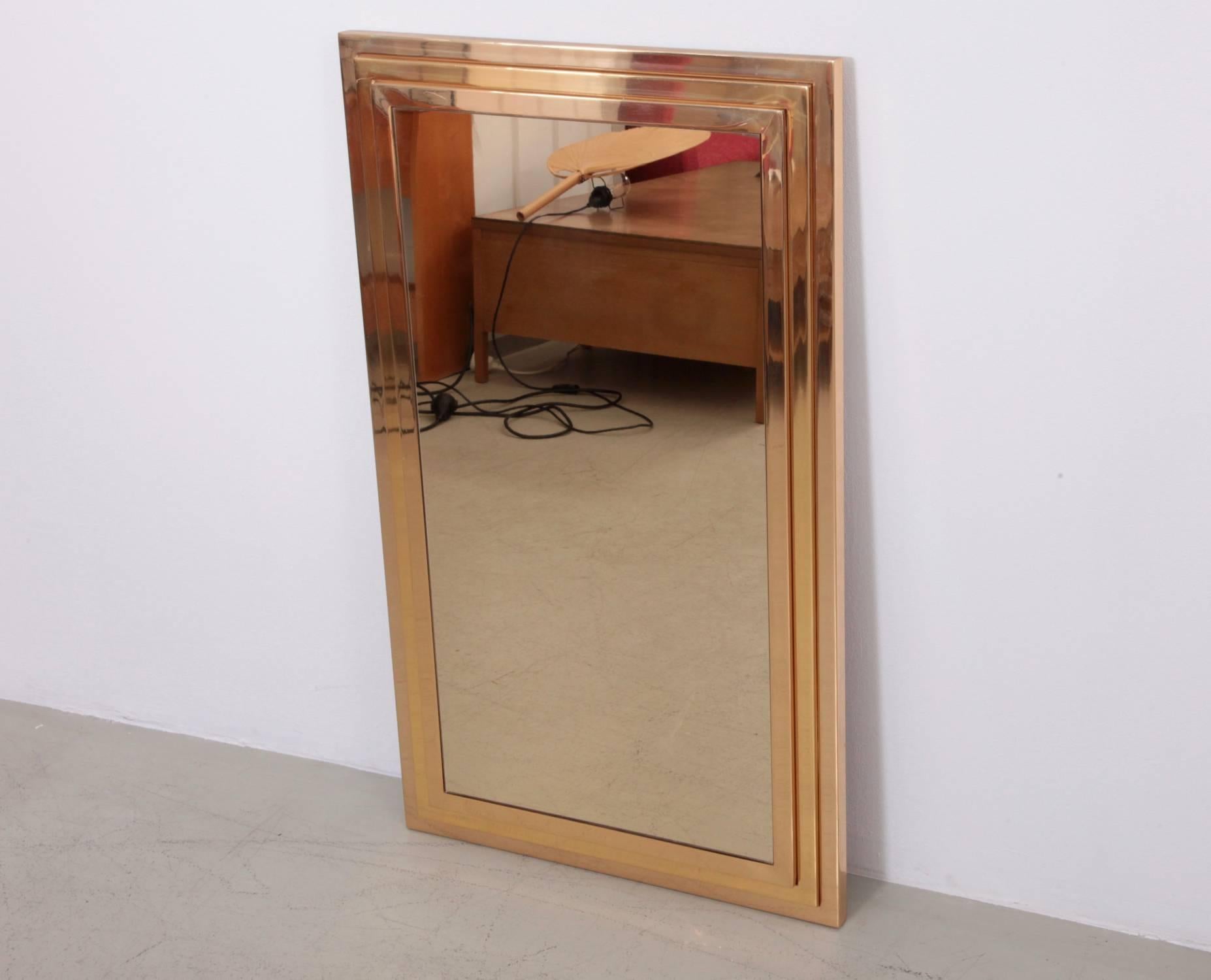 Wonderful brass mirror in high end quality with a golden colored mirror. The mirror is made in the manner of Willy Rizzo and it is in a very good condition.