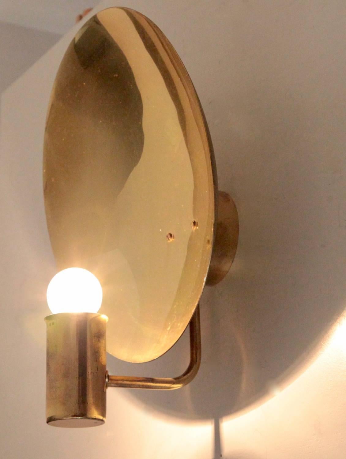 Nice pair of H.A. Jakobsson wall lamps with a brass parabol shade. Nice patina!