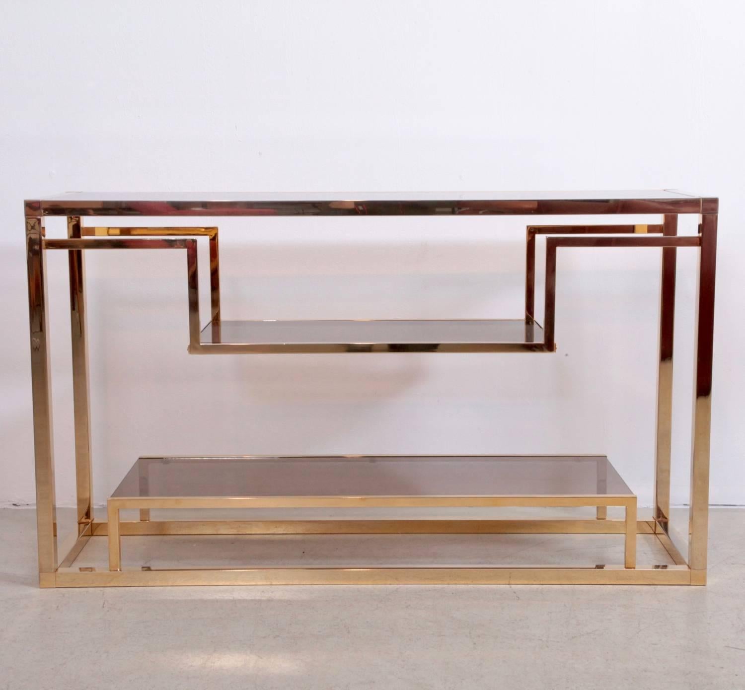 Monumental brass and smoked glass shelf by Romeo Rega. The shelf is in excellent condition.