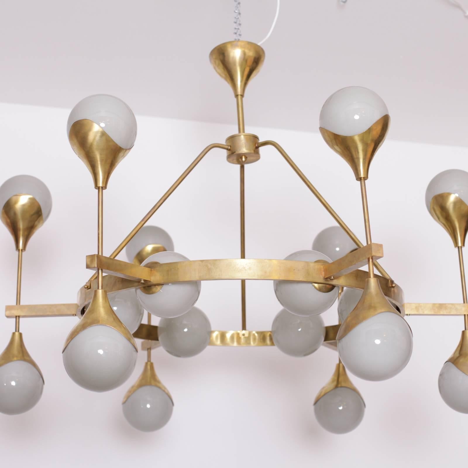 Stunning, very large Murano glass and brass chandelier attributed to Stilnovo. The chandelier has a very impressing size and is a real eyecatcher in every room. The chandelier is in excellent condition. Delivery time is about 5-6 weeks. 
18 x E14