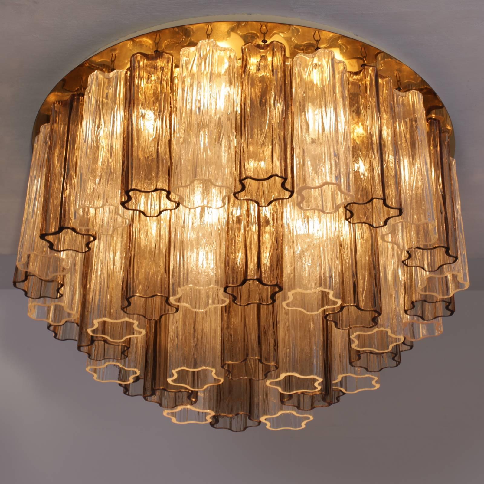 Wonderful huge, signed three-tier Murano glass tronchi flush mount or chandelier by Kalmar. The chandelier is from the 1960s and 48 hand blown Murano glasses in two colors hanging on a brass plate. The chandelier is lighted with 13 bulbs and in good