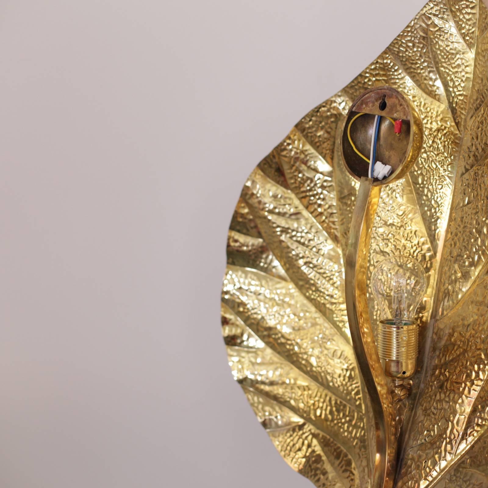 Set of two wonderful huge rhaburb leaf wall lamps by the Italian designer Tommaso Barbi. The lamps are made of brass and the reflexion of the light on the brass brings a cozy atmosphere in every room. The lamps are icons of the 1970s design and they