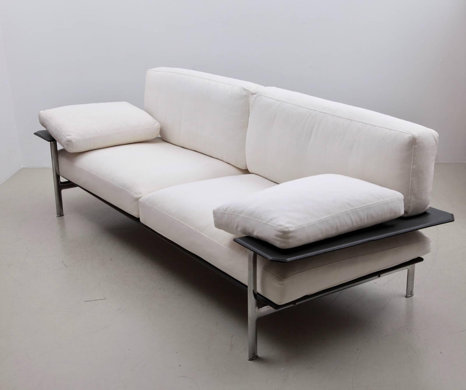 Diesis sofa, designed by Antonio Citterio and Paolo Nava, Italy, B&B Italia, 1979. The three-seat sofa with the light original cream colored fabric down filled cushions. Finished in the polished metal with brass detail. 
Literature: Repertorio del