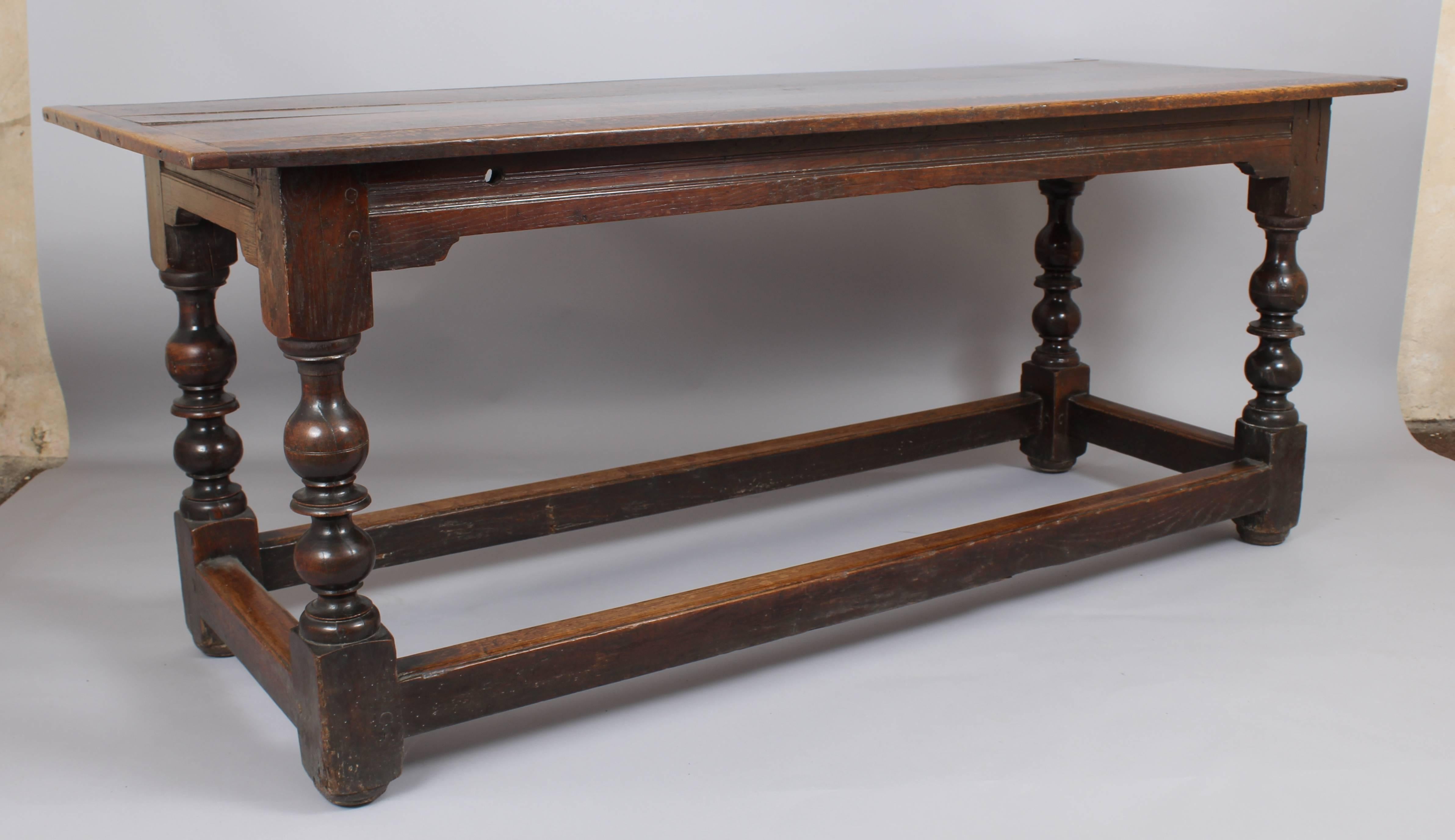 Fine late 17th century oak table of good rich colour and patina; the planked and cleated top on a joined frame with bold baluster-shaped turned legs and moulded stretcher-rails, circa 1690.