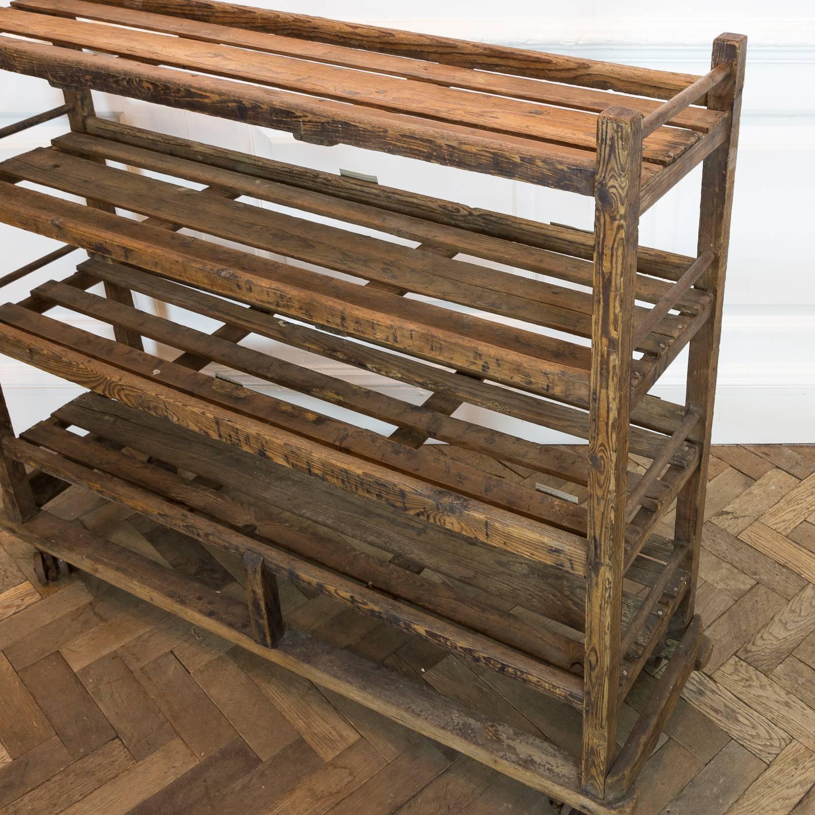 A rustic reclaimed pine shoe rack of French origin.