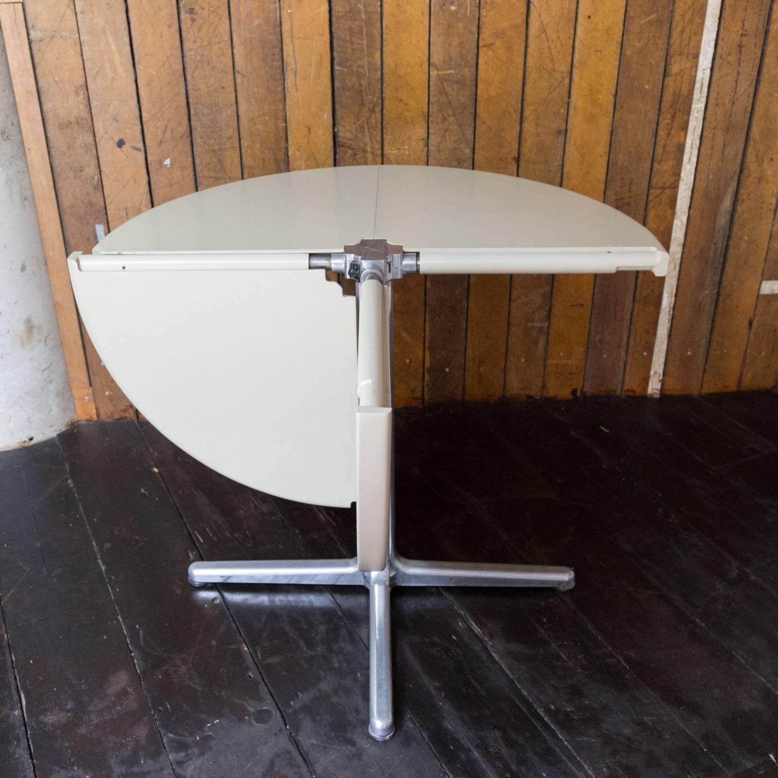 A revolutionary, folding table made from plastic and cast aluminium. In excellent condition throughout. Single-owner piece. Matching chairs also available separately.