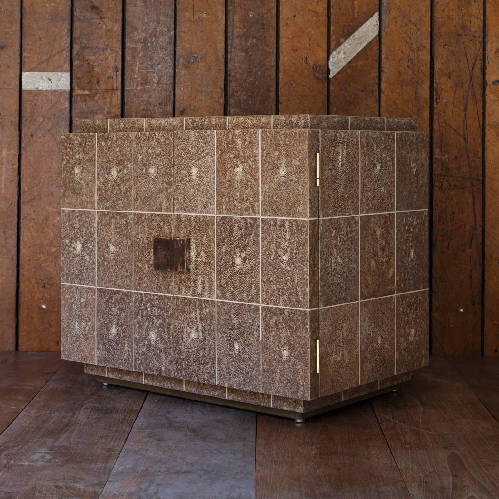 This French Art Deco shagreen (stingray leather) box features original brass locks and silver clasps. Inlaid with bone, the doors are held fast by later hinges.